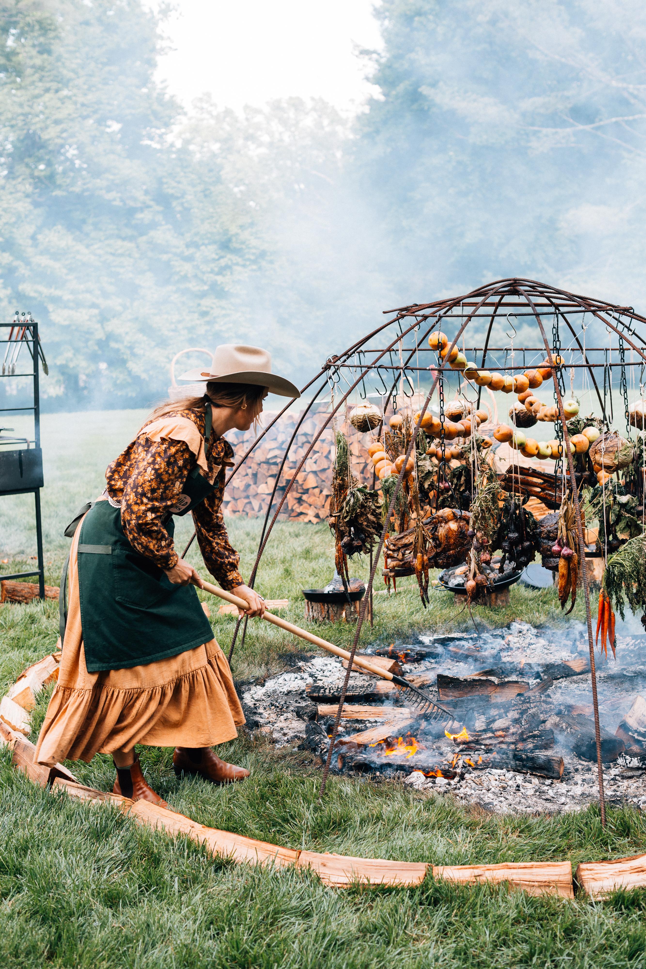 Sarah Glover cooking on an open fire.