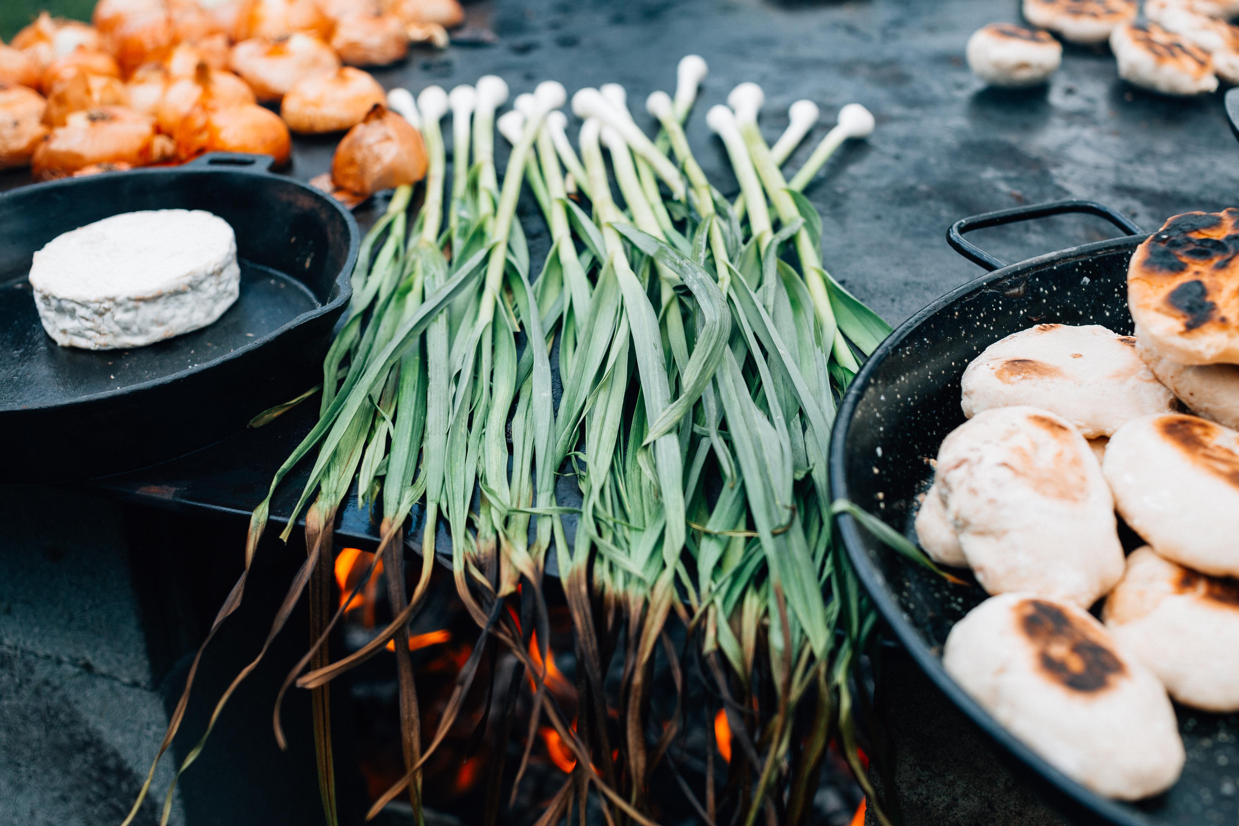 Ingredients cooking on an open flame.