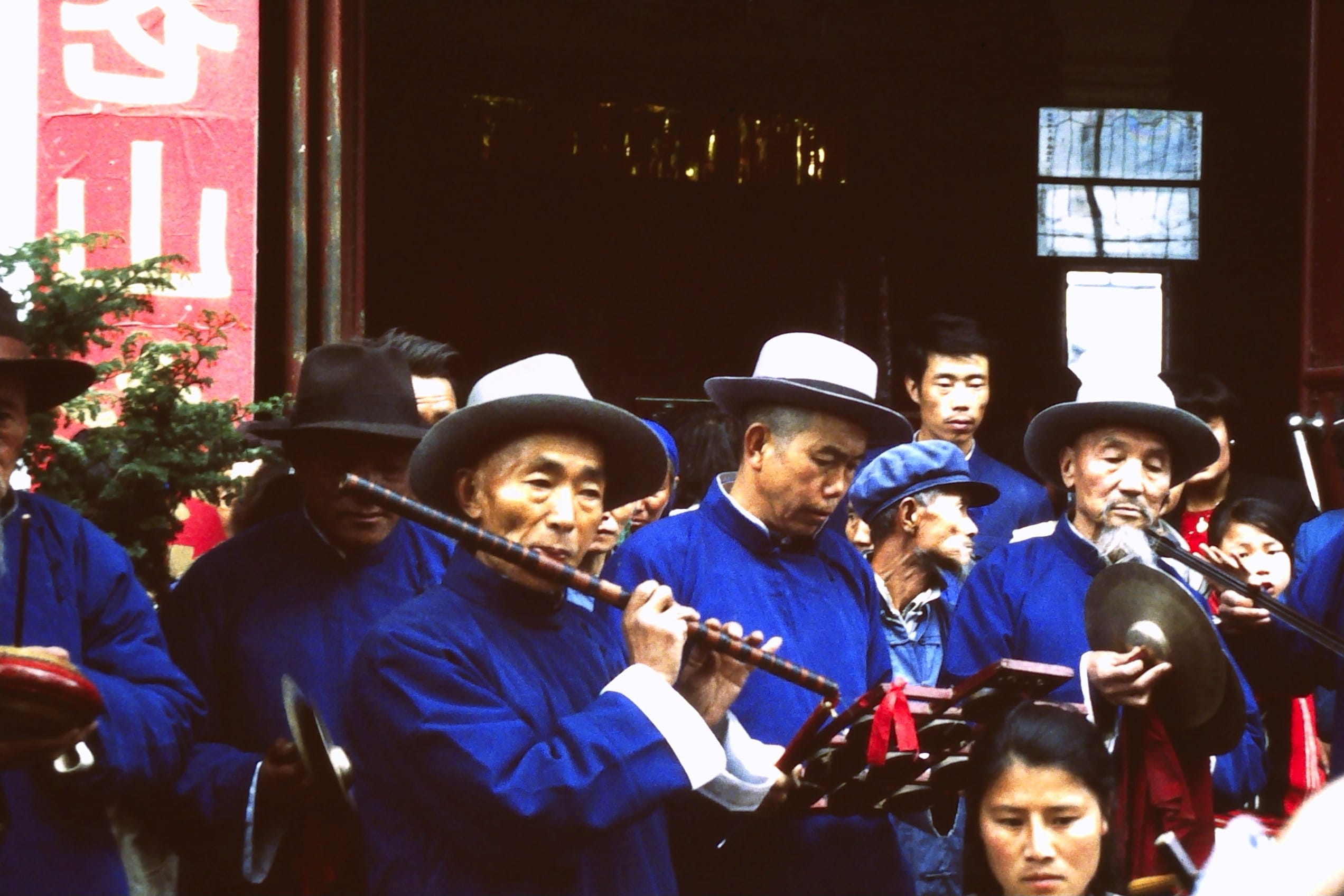 Band of musicians Dali Chinese new year each wearing traditional dyed indigo clothes.