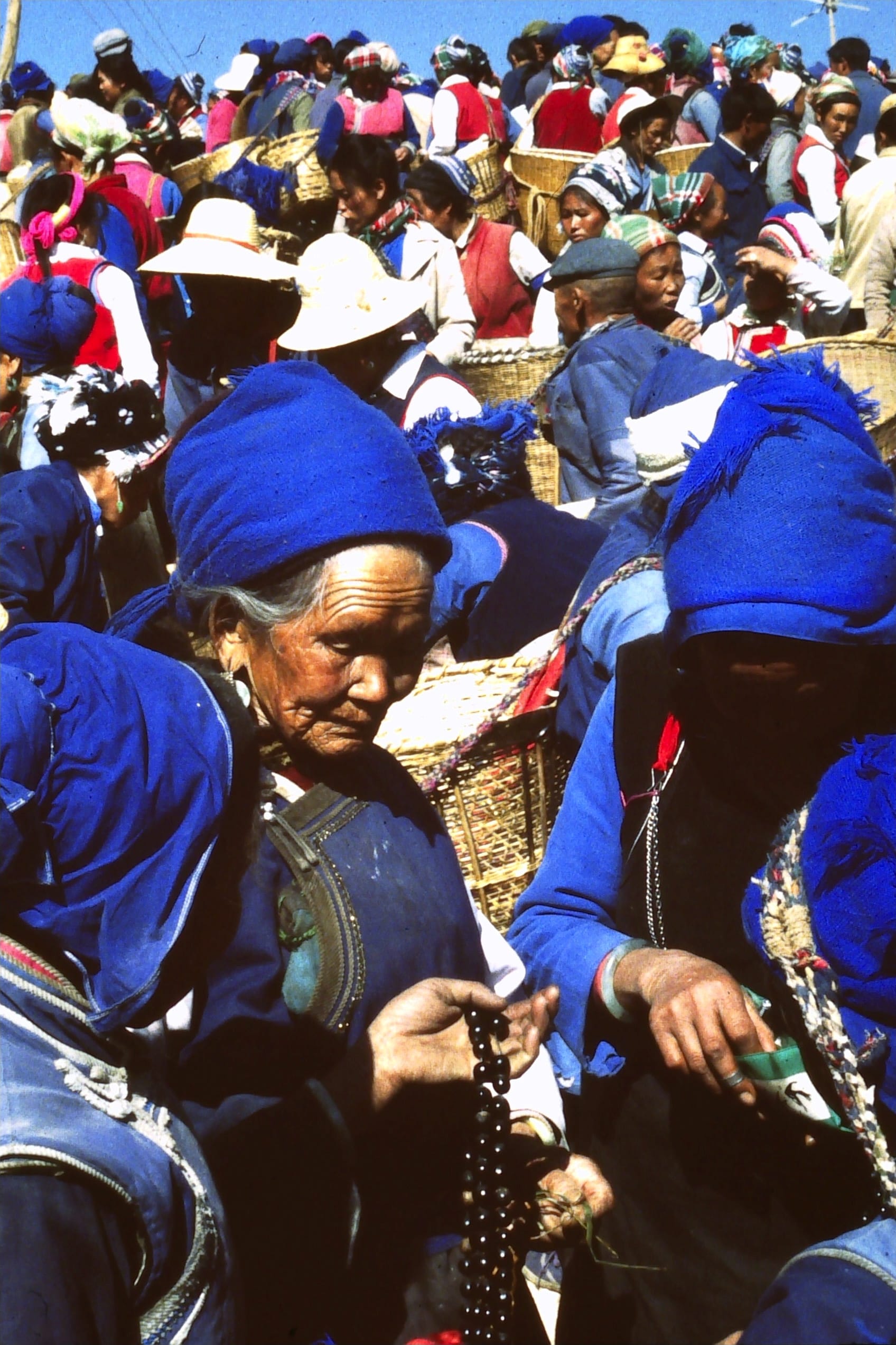 Open market outside Dali. Women wearing traditional dyed indigo clothes looking for bargains.