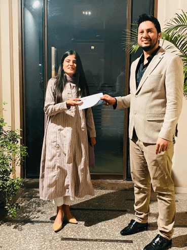 CEO of CodeAutomation presenting a prize to an employee during a company recognition event
