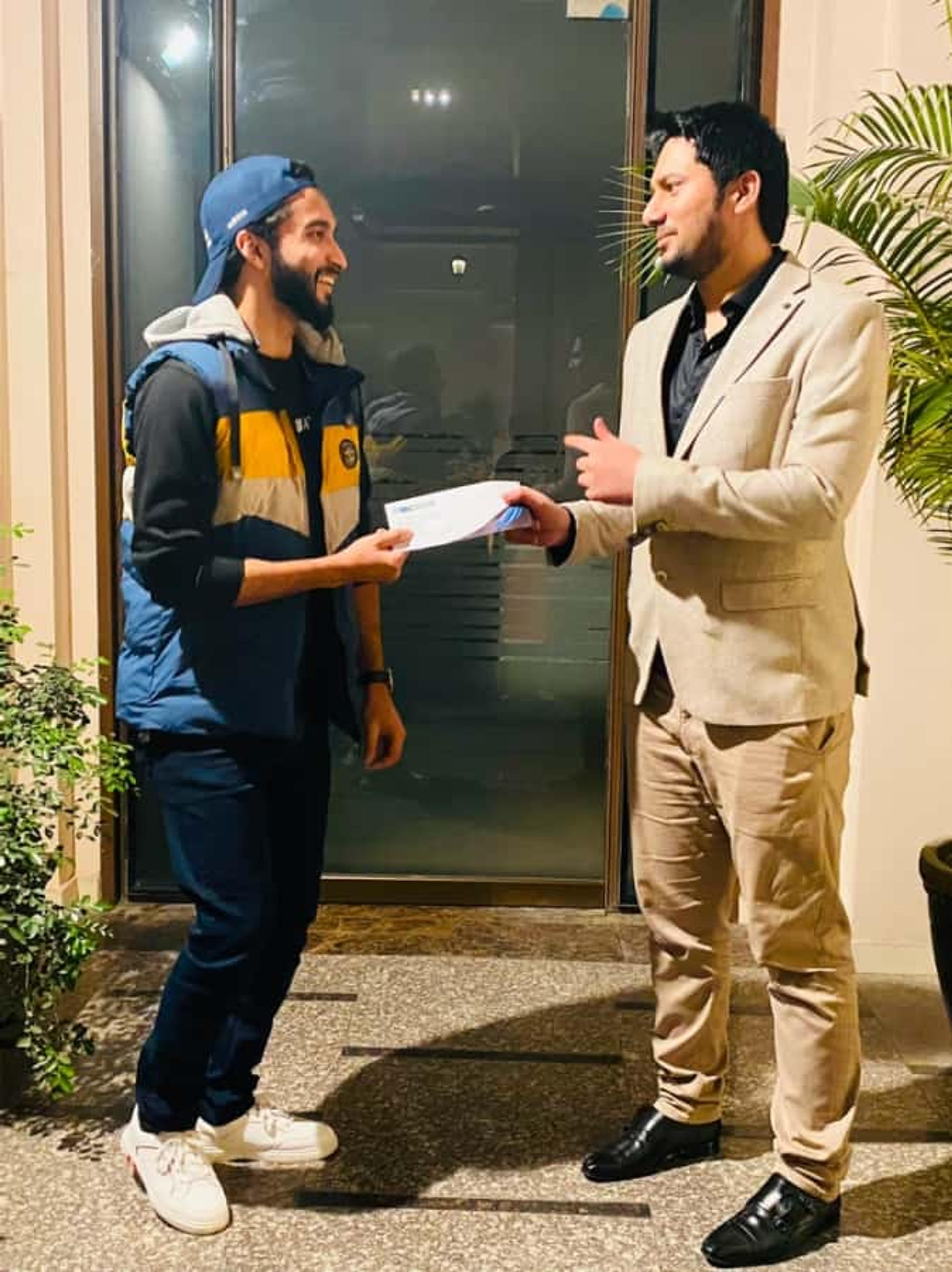 CodeAutomation CEO awarding an employee during a recognition ceremony.