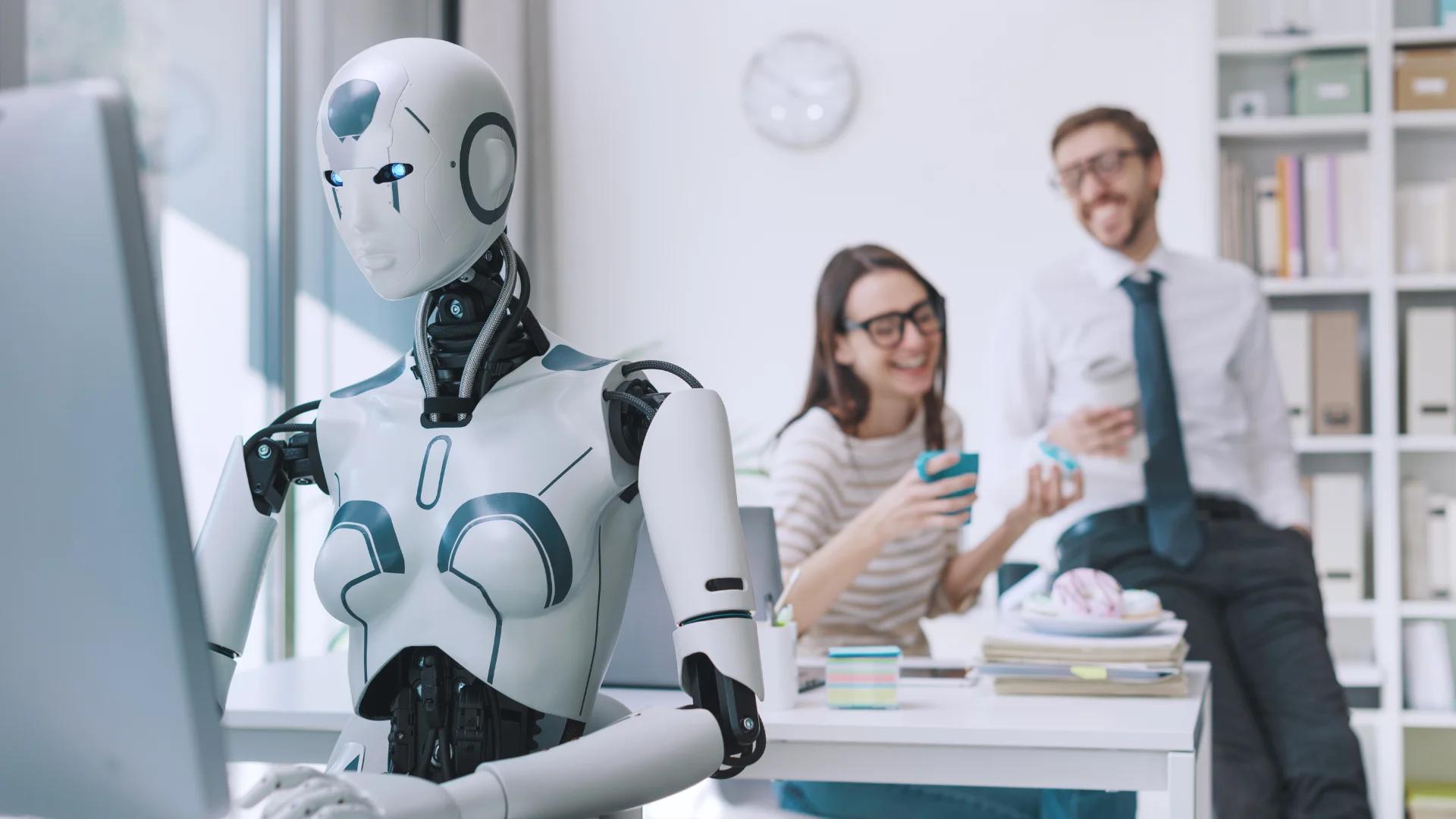 AI robot working alongside humans in an office, representing the seamless integration of AI in modern workspaces and collaboration at CodeAutomation.ai.
