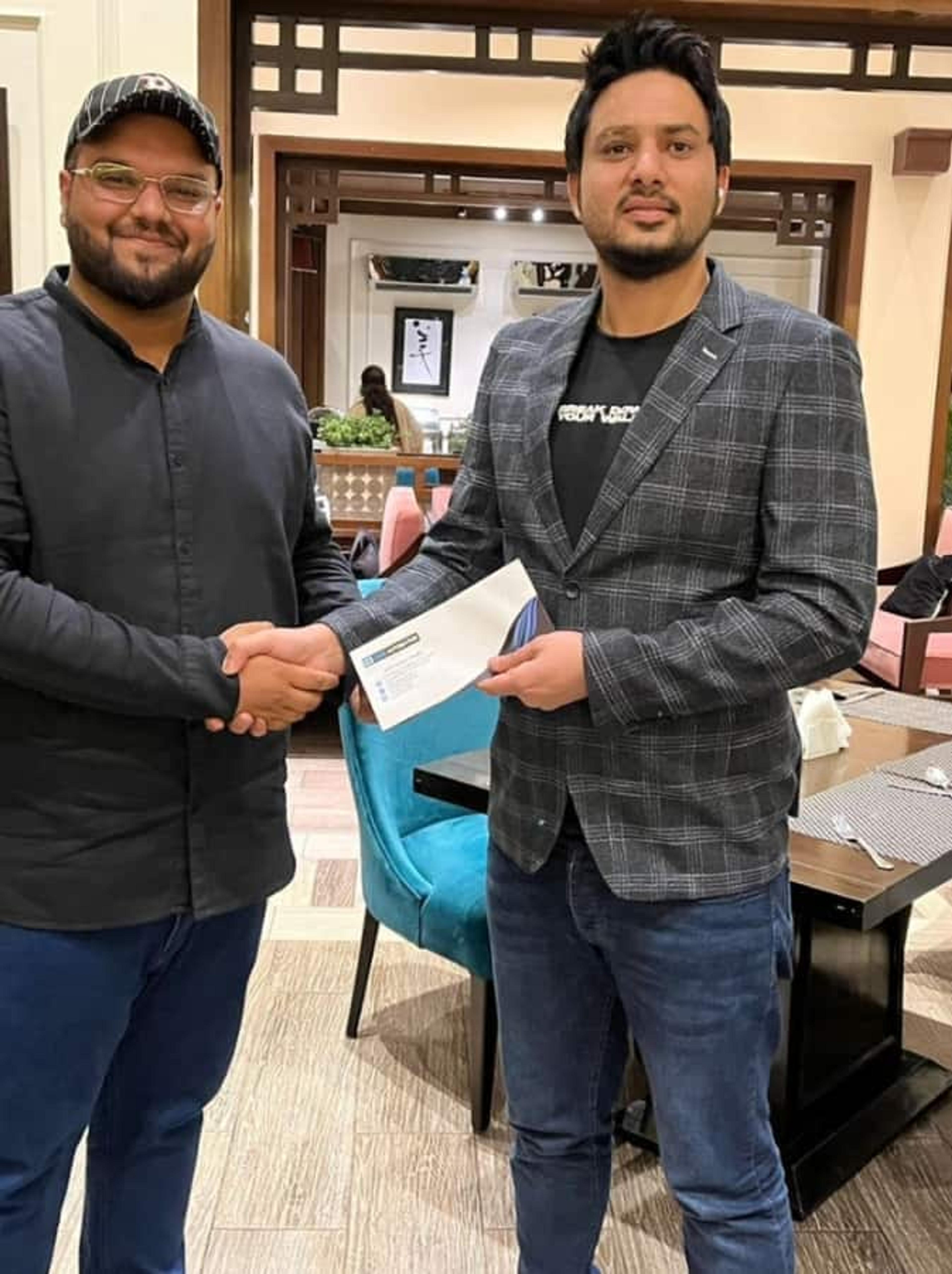 Company appreciation event at CodeAutomation: CEO presents an achievement award to a dedicated team member.