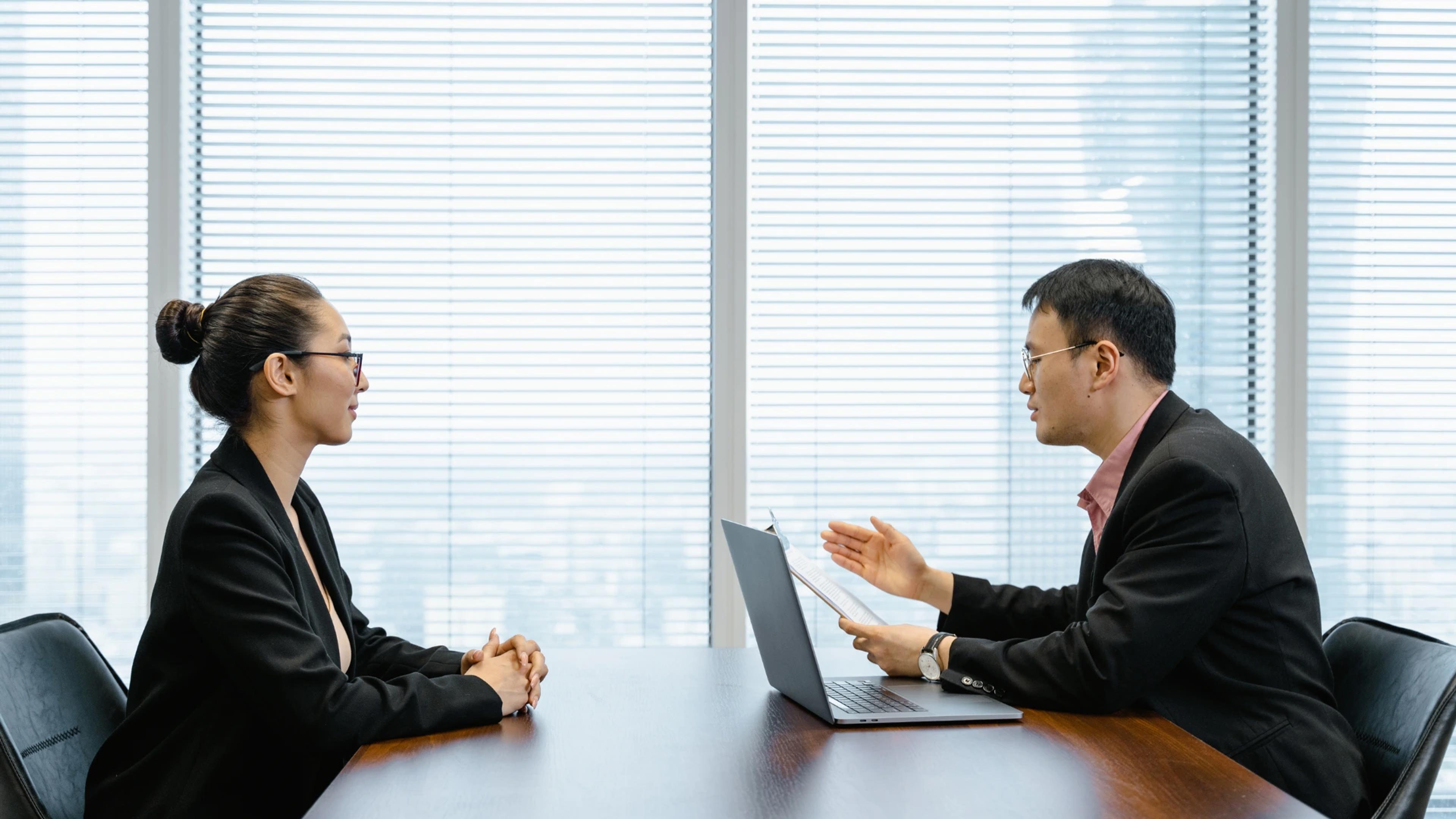 Two professionals engaged in a business interview, discussing strategies and opportunities in AI development at https://codeautomation.ai/