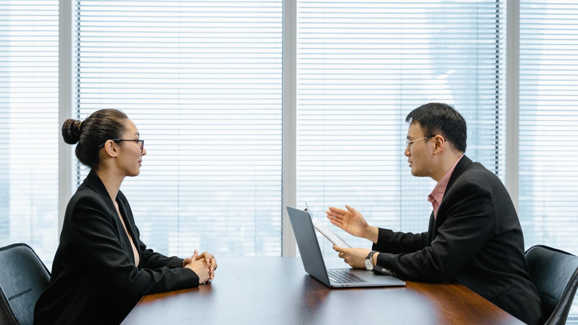 Two professionals engaged in a business interview, discussing strategies and opportunities in AI development at https://codeautomation.ai/
