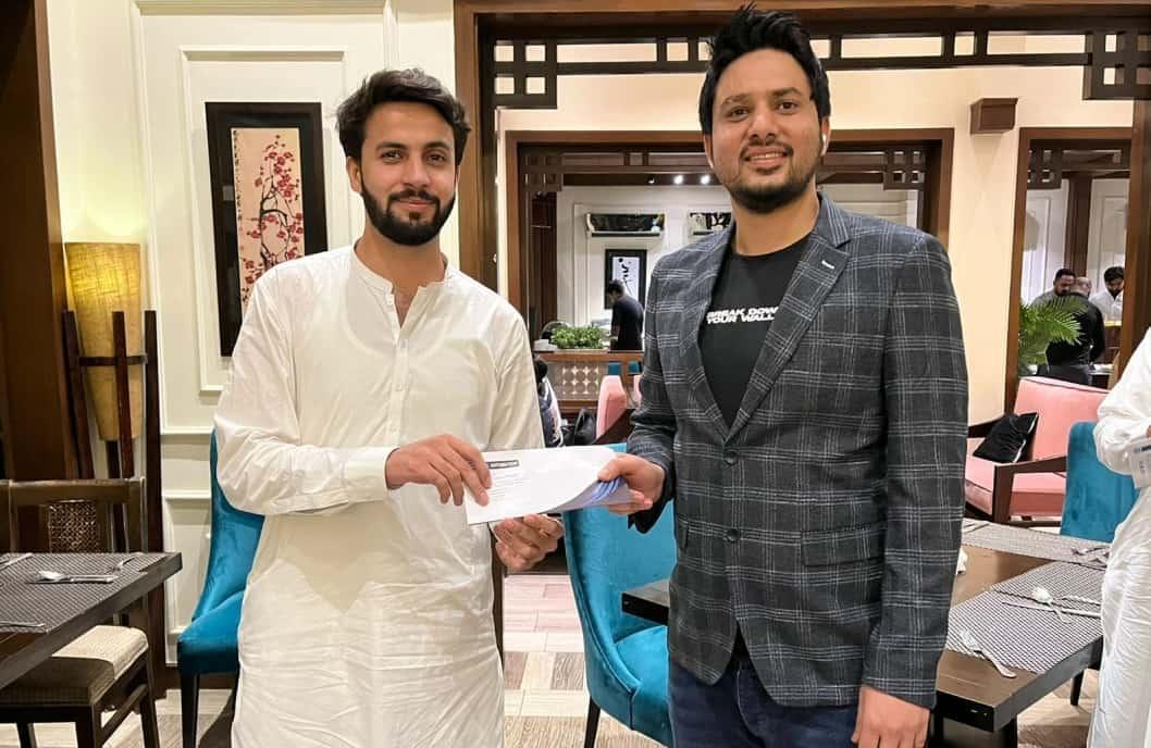 CodeAutomation CEO presenting an achievement award to an employee during a company appreciation event.