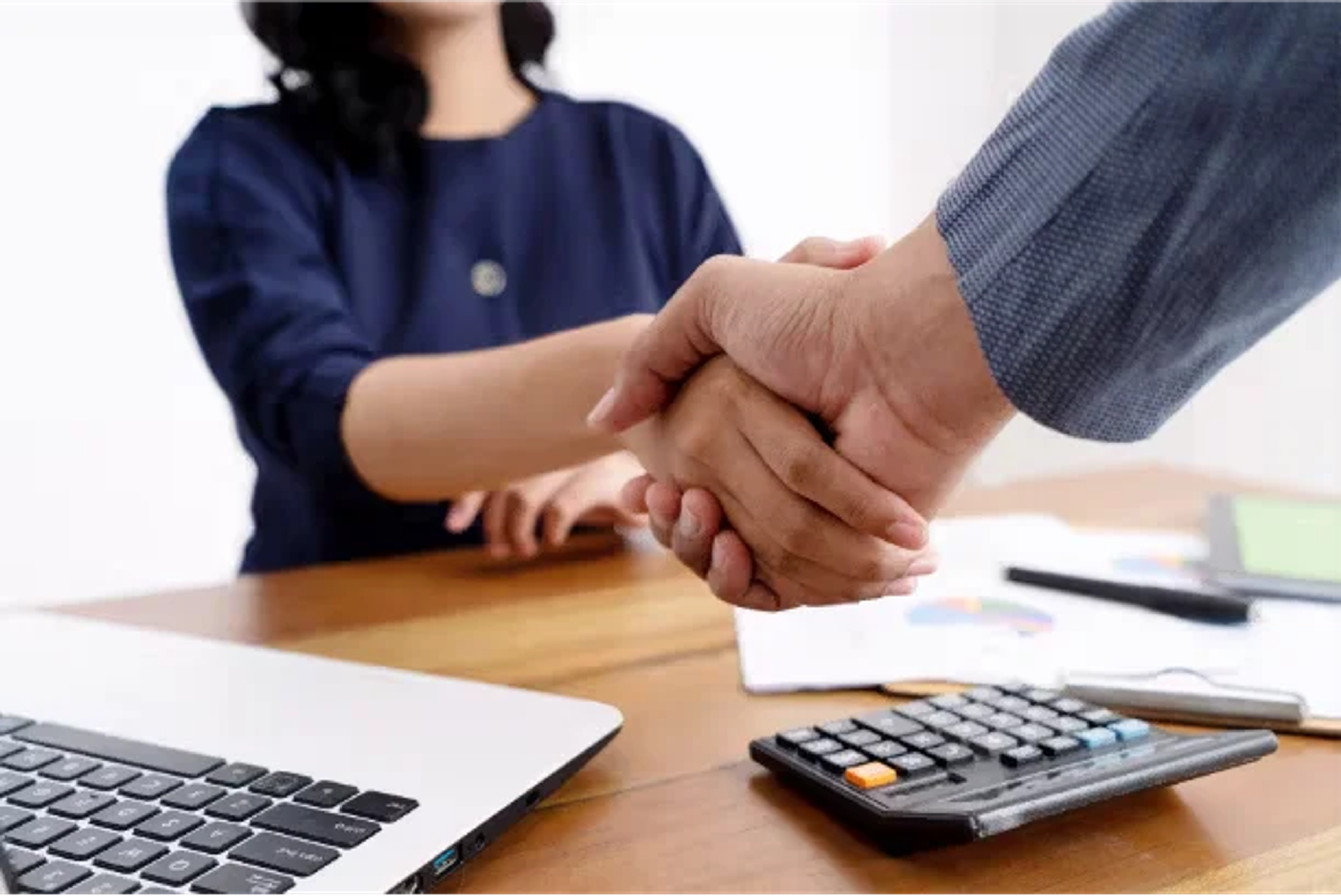 Business partnership handshake in office setting representing GHL CRM customization and automation services by CodeAutomation.ai, US-based software company specializing in business automation, CRM customizations, and AI agent development