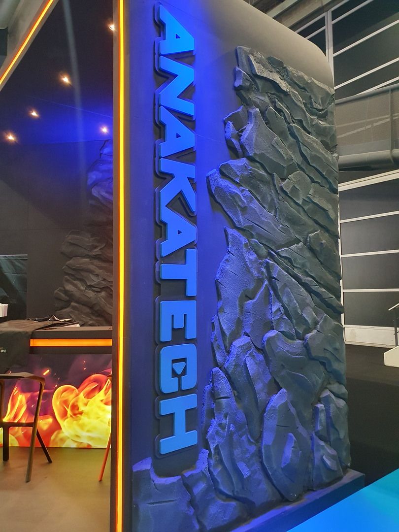 Curved corner with raised Anakatech lettering and sculptural rock cladding