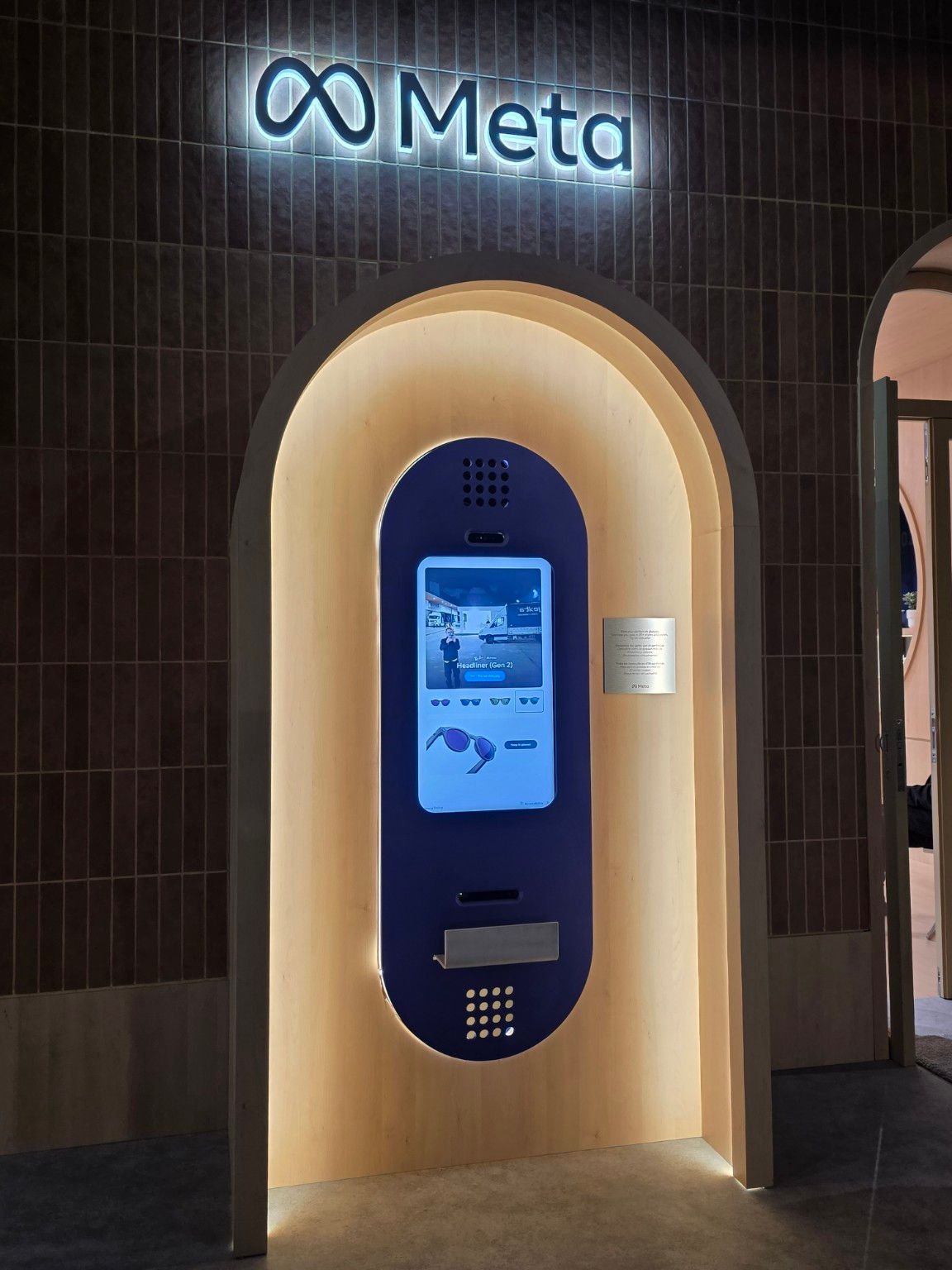 Blue demonstration terminal framed by a curved timber niche and warm lighting