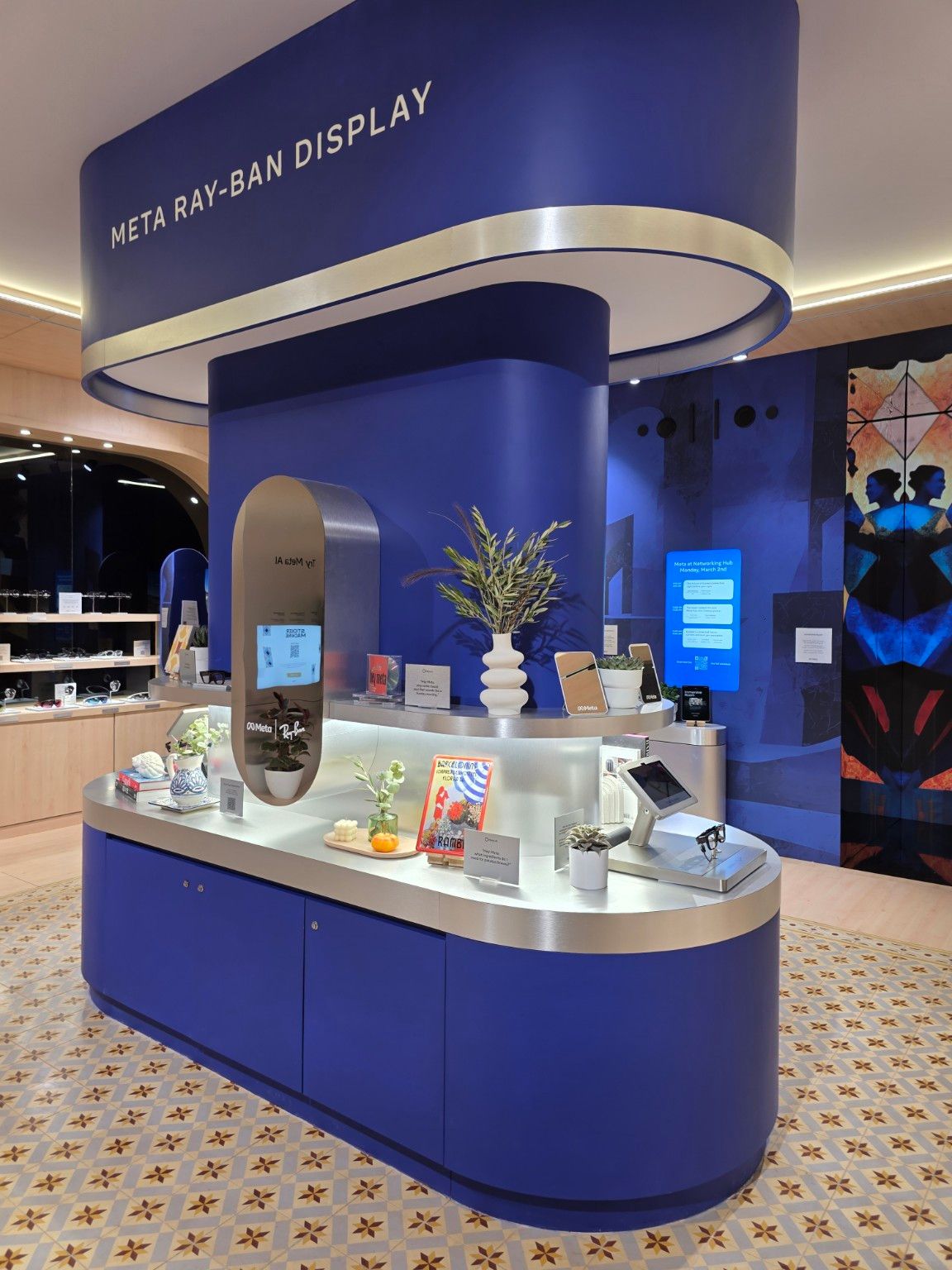 Detail of the Meta Ray-Ban Display unit with a mirror, lighting and metallic surfaces