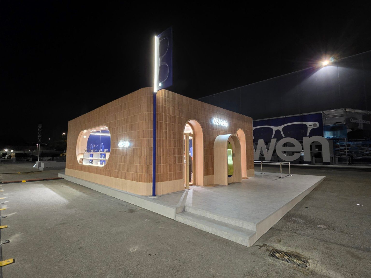 Night-time exterior view of the Meta pavilion, platform and side display window