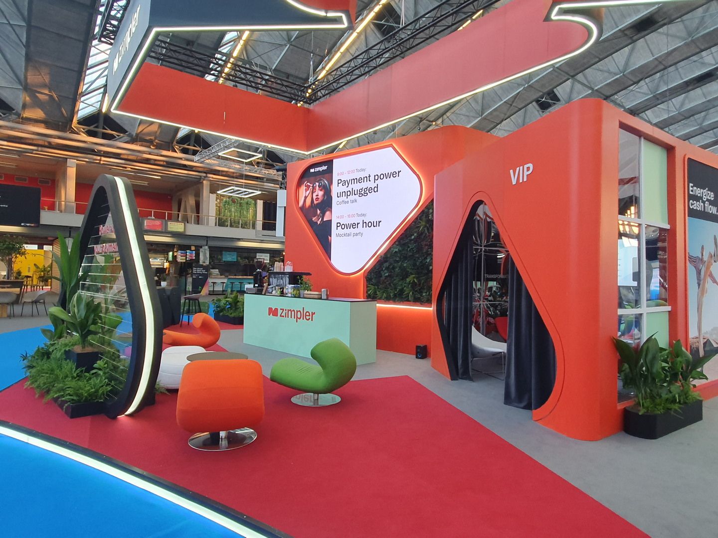 View of the Zimpler stand at RAI Amsterdam with integrated screen, hospitality and networking areas