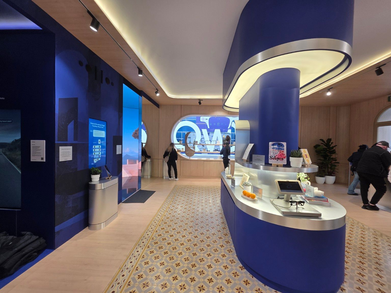 Curved display furniture and integrated screens inside the Meta pavilion