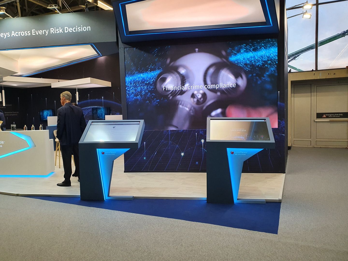LexisNexis Risk Solutions stand at SIBOS 2022 in Amsterdam with large LED screen and blue lighting