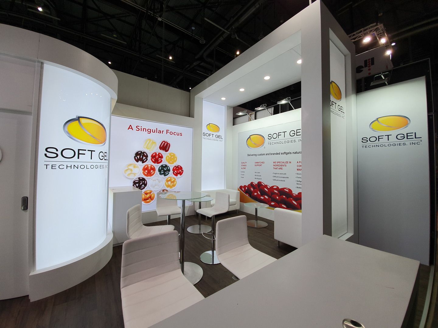 Meeting area beneath the illuminated white structure — SoftGel Technologies · Vitafoods