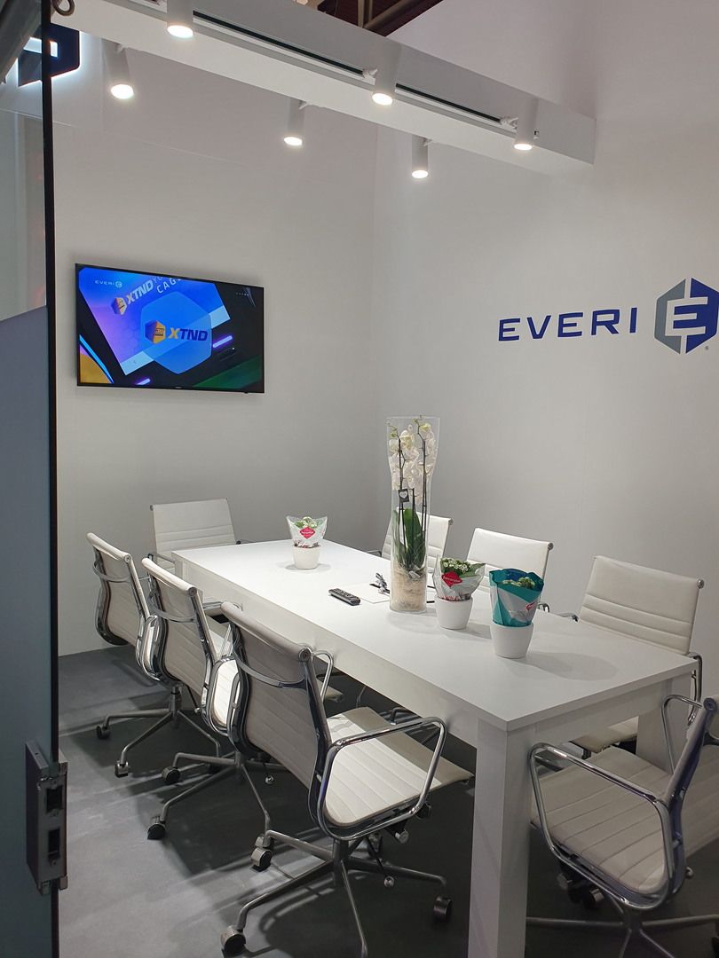 Everi meeting room with white table, six chairs, screen and glazed entrance