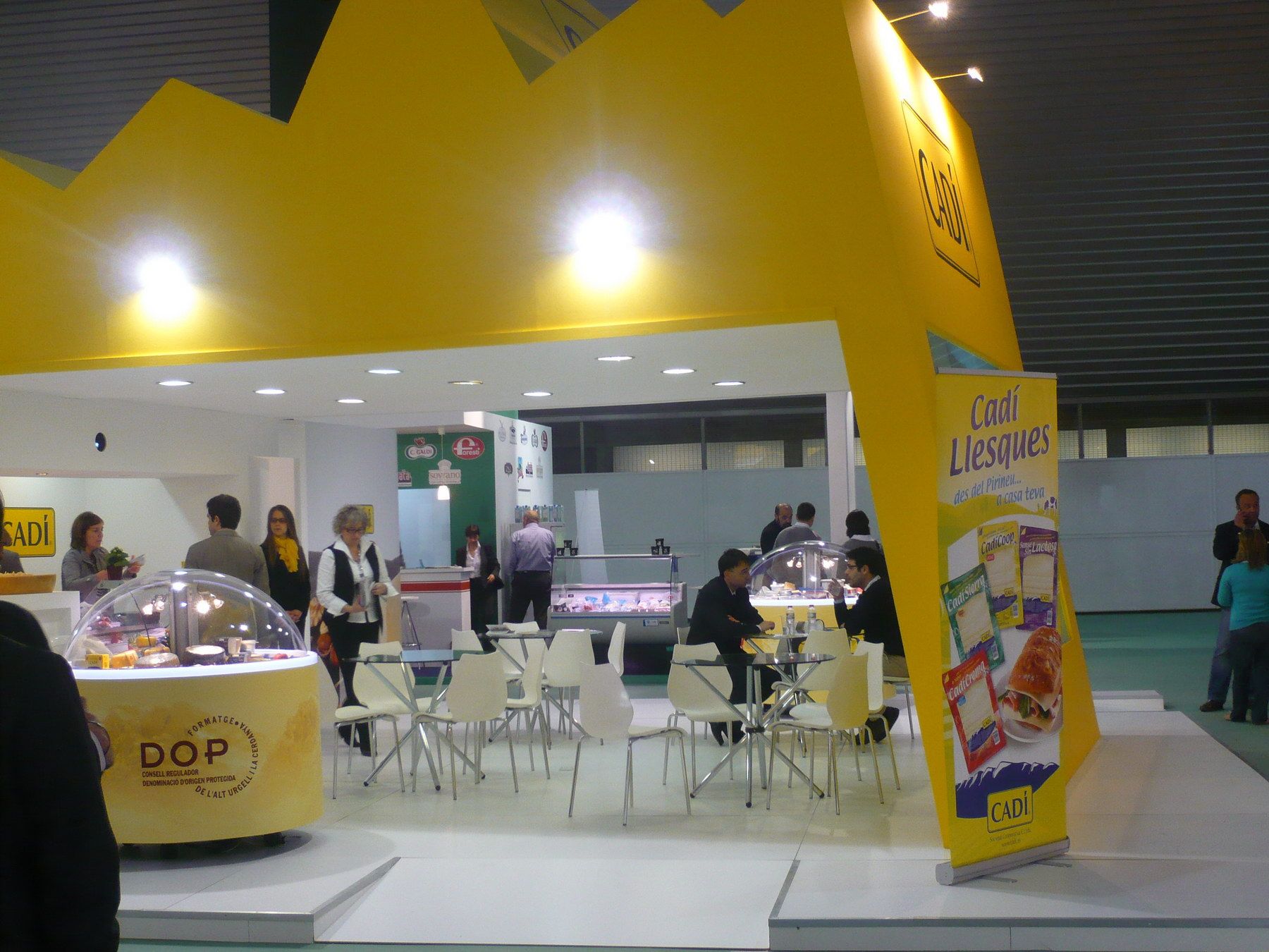 Reception and tables beneath the mountain-shaped profile — Quesos Cadí · Alimentaria