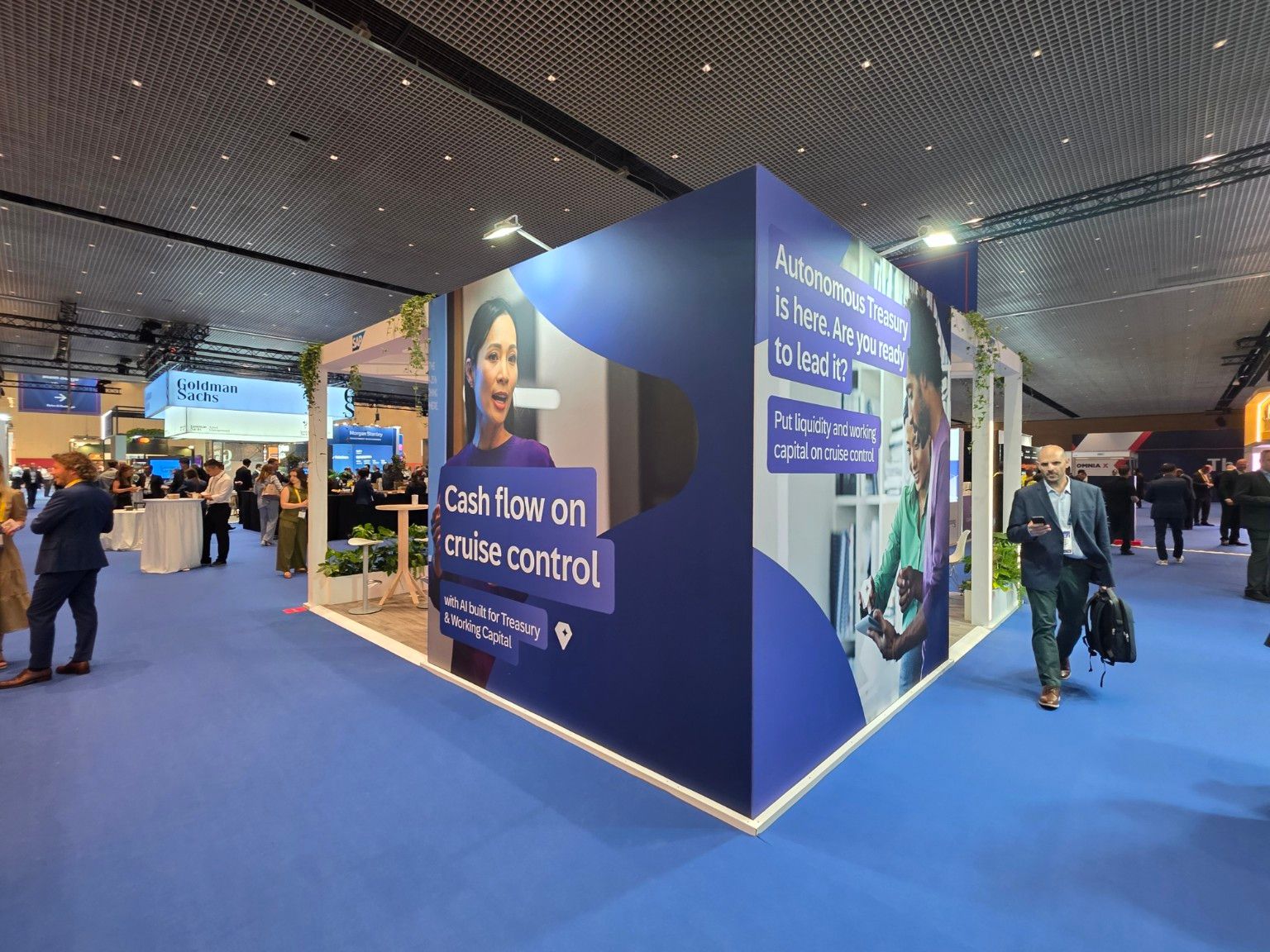Large-format treasury graphics on the outer walls of the SAP Taulia stand
