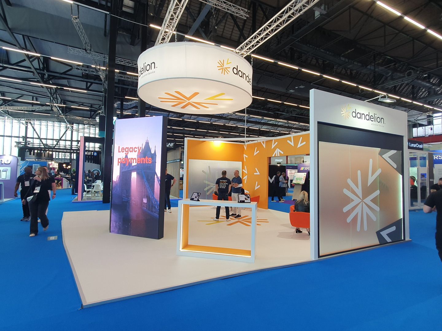 Detail of the Dandelion stand for Money20/20 Amsterdam with orange branding and presentation area