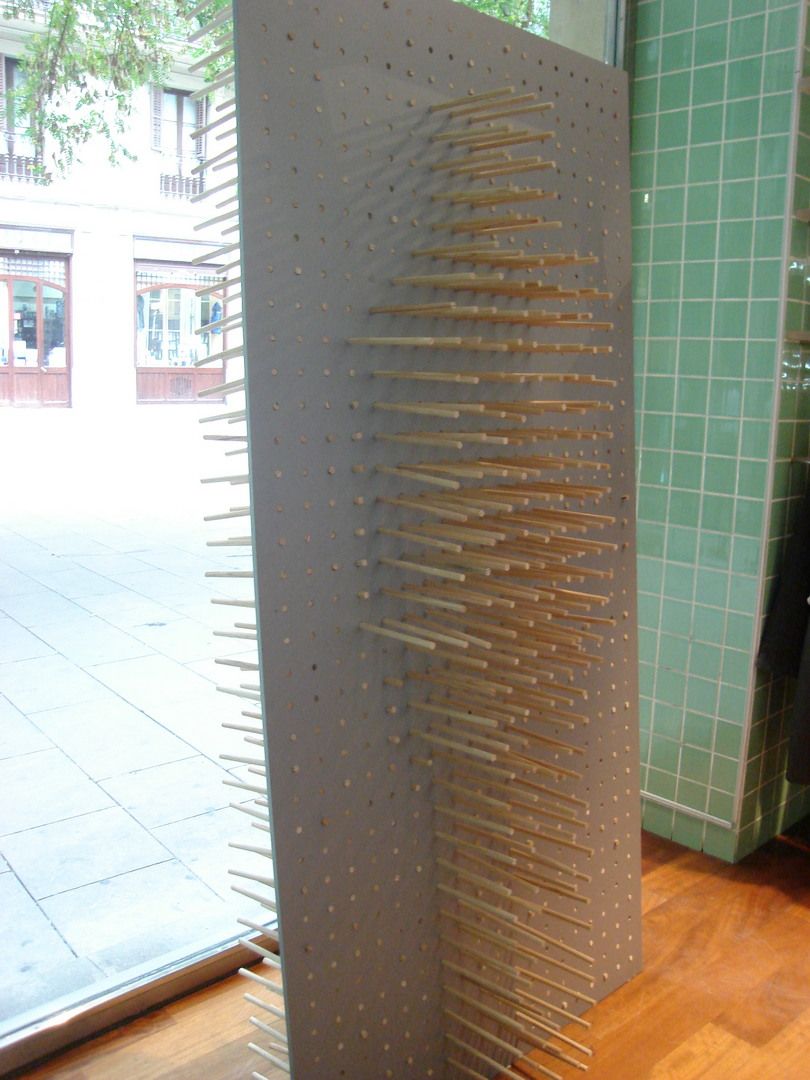 Construction detail of a rod-based window display structure for Custo Barcelona