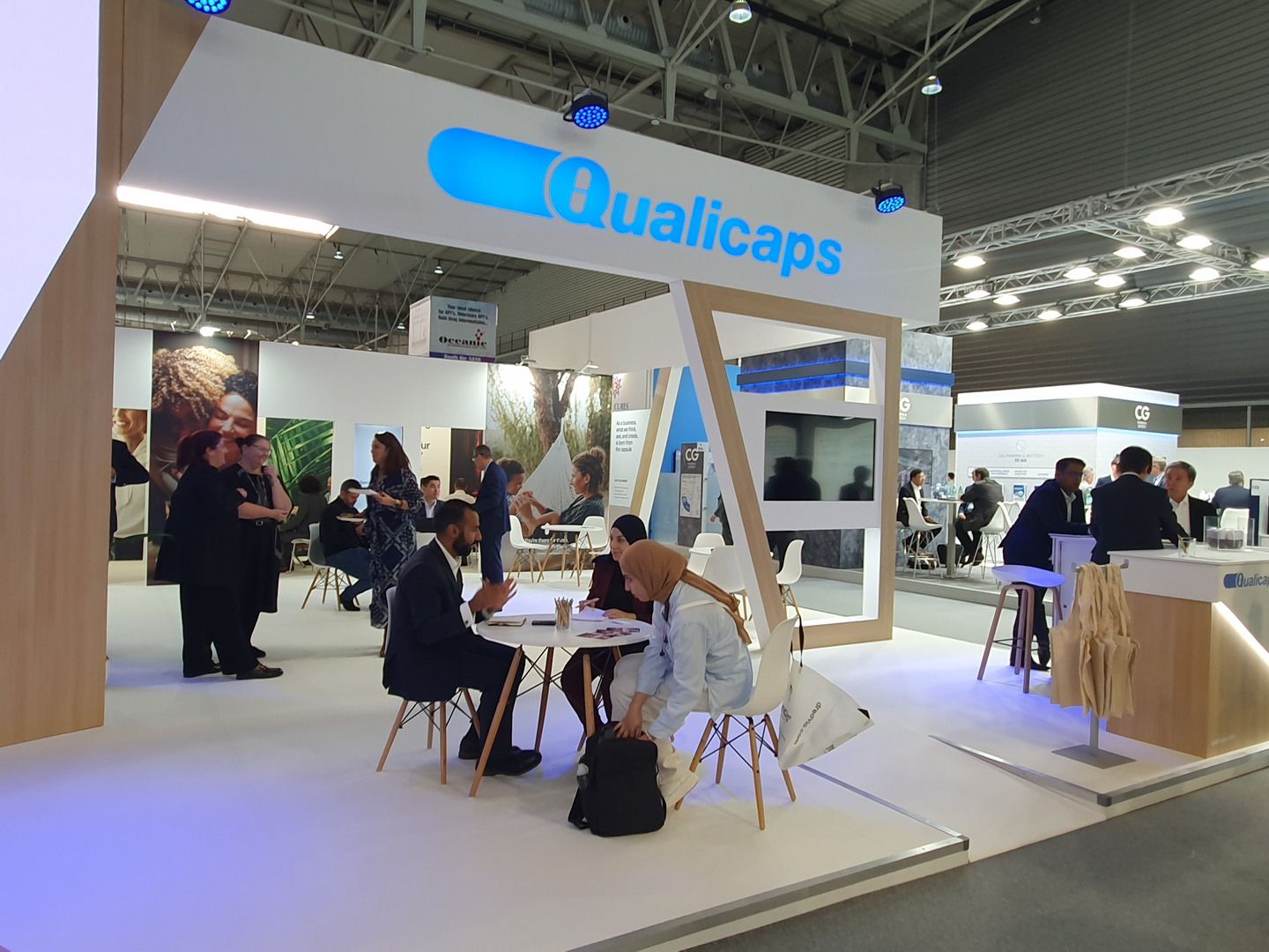 Open tables beneath the branded structure — Qualicaps · CPHI