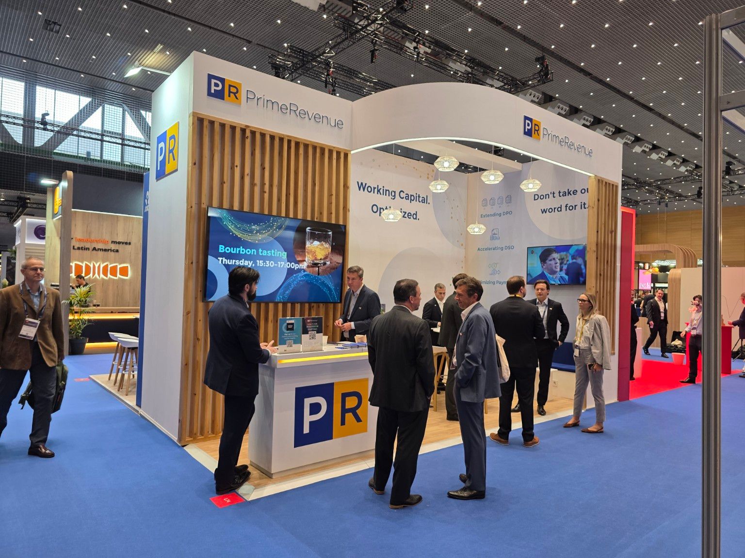 Reception counter and screen integrated into the slatted wall of the PrimeRevenue stand