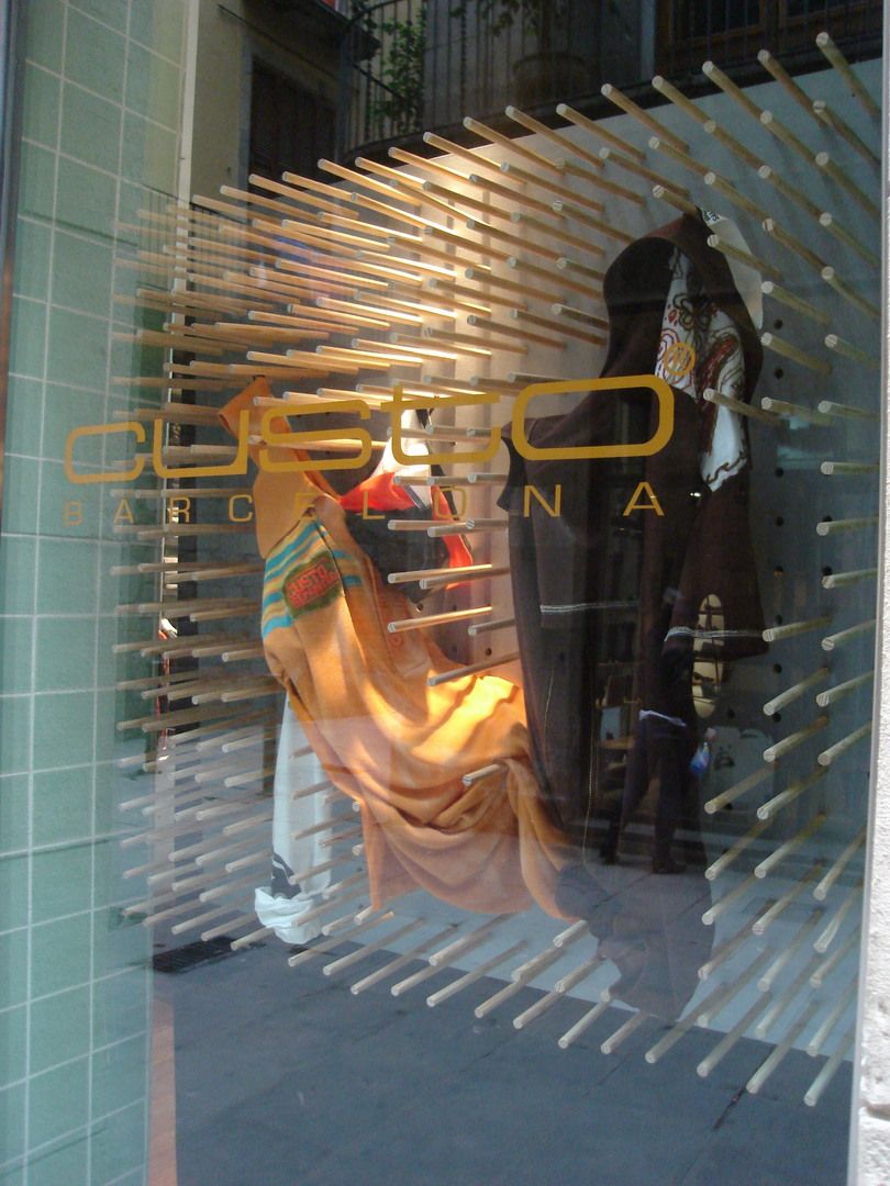 Custo Barcelona window display with garments integrated into a sculptural timber installation