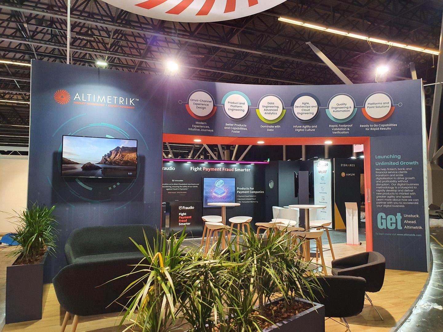 View of the Altimetrik stand at RAI Amsterdam with branding, screens and networking space