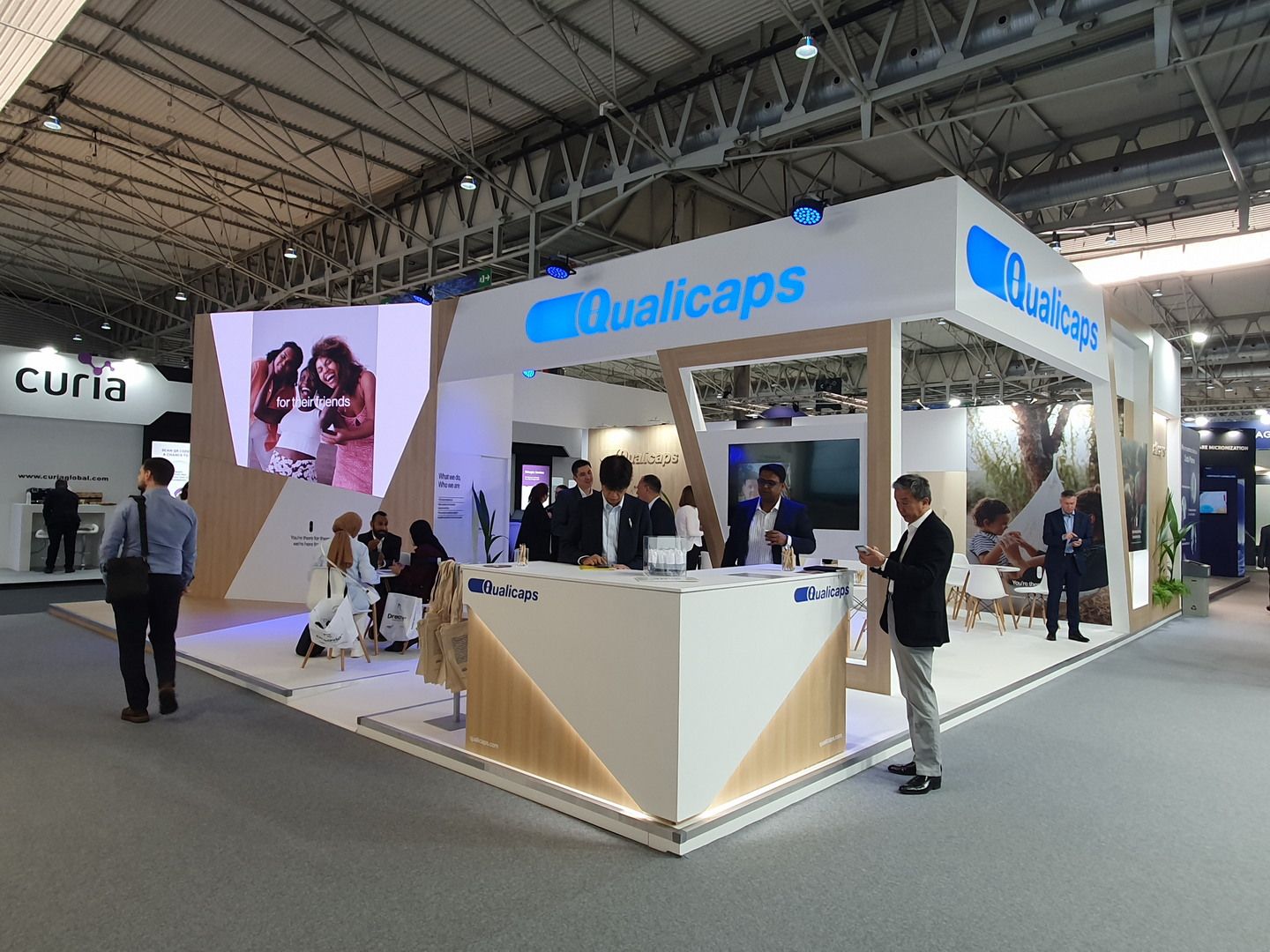 Reception and meeting areas around the stand perimeter — Qualicaps · CPHI