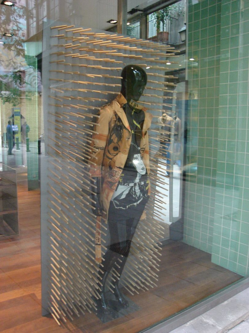 Custo Barcelona window display with mannequin and timber rod display structure