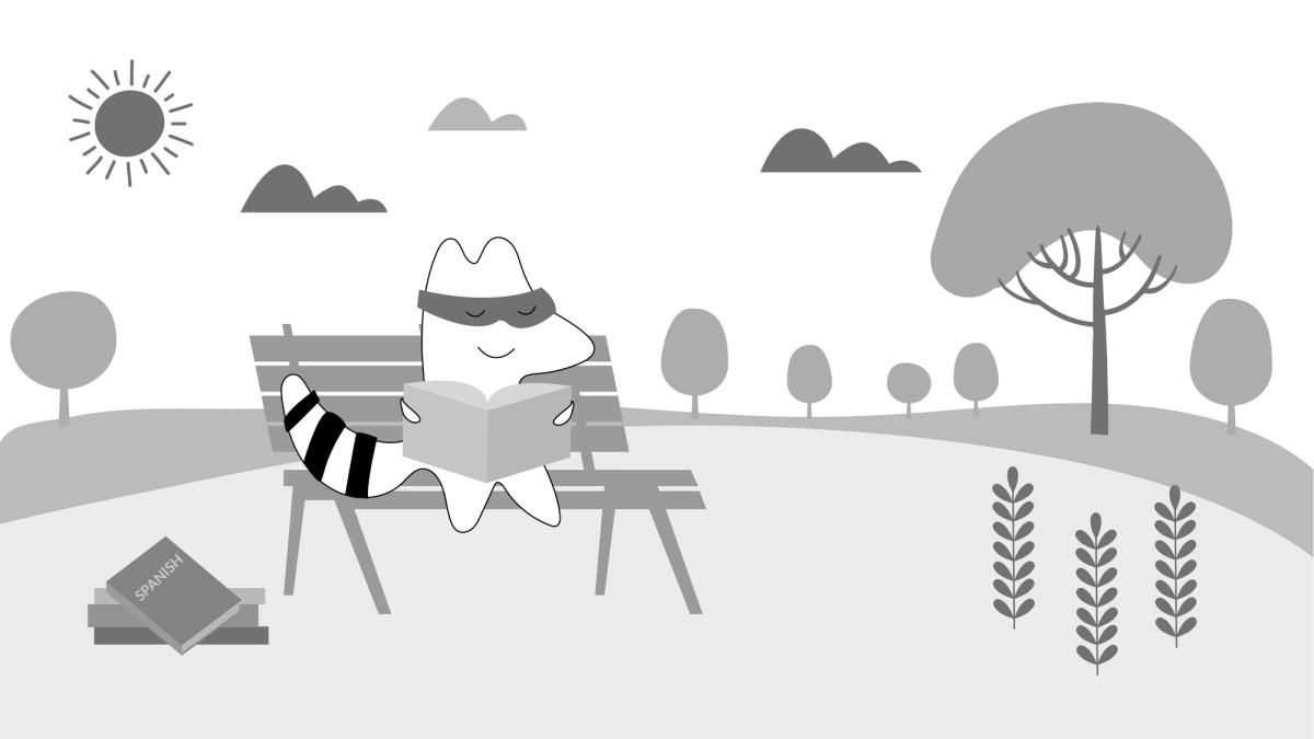 Iggy sits down in a park with a Spanish textbook in his hands, studying. 