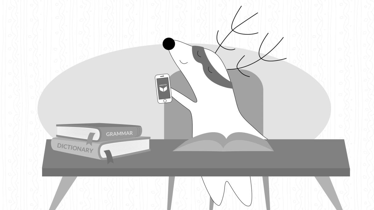 Soren sits down at his desk, with his smartphone in hand but also with a dictionary and a notebook, using them to take down notes.