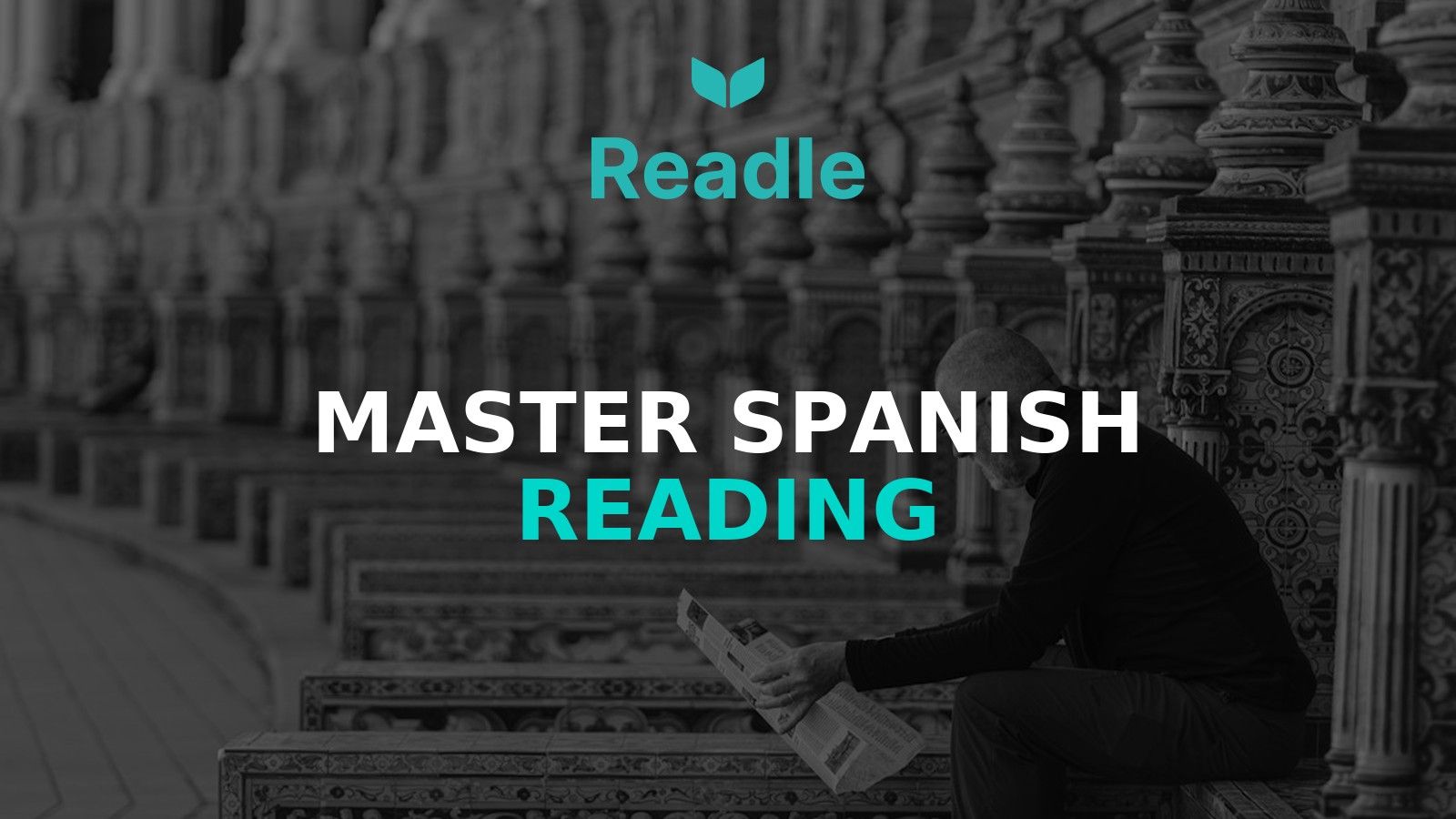 A man sitting on a bench reading a book