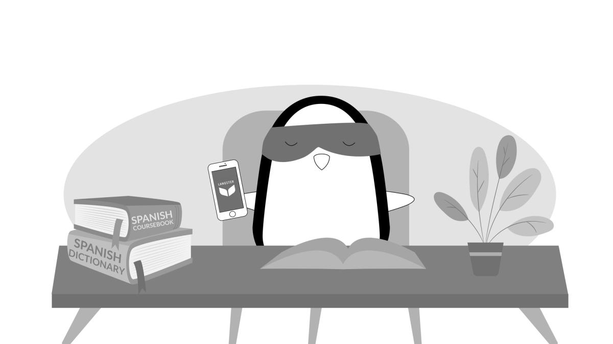 Pocky is using his smartphone to learn Spanish with the Langster app. There are a dictionary and a language coursebook by his side as well.