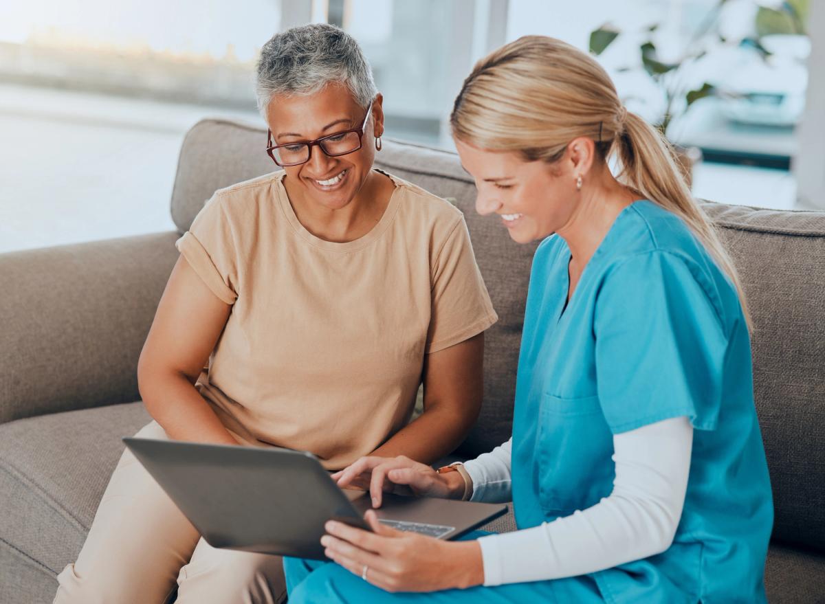 Woman and doctor sitting with computer