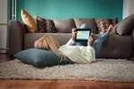 woman relaxing on floor with tablet