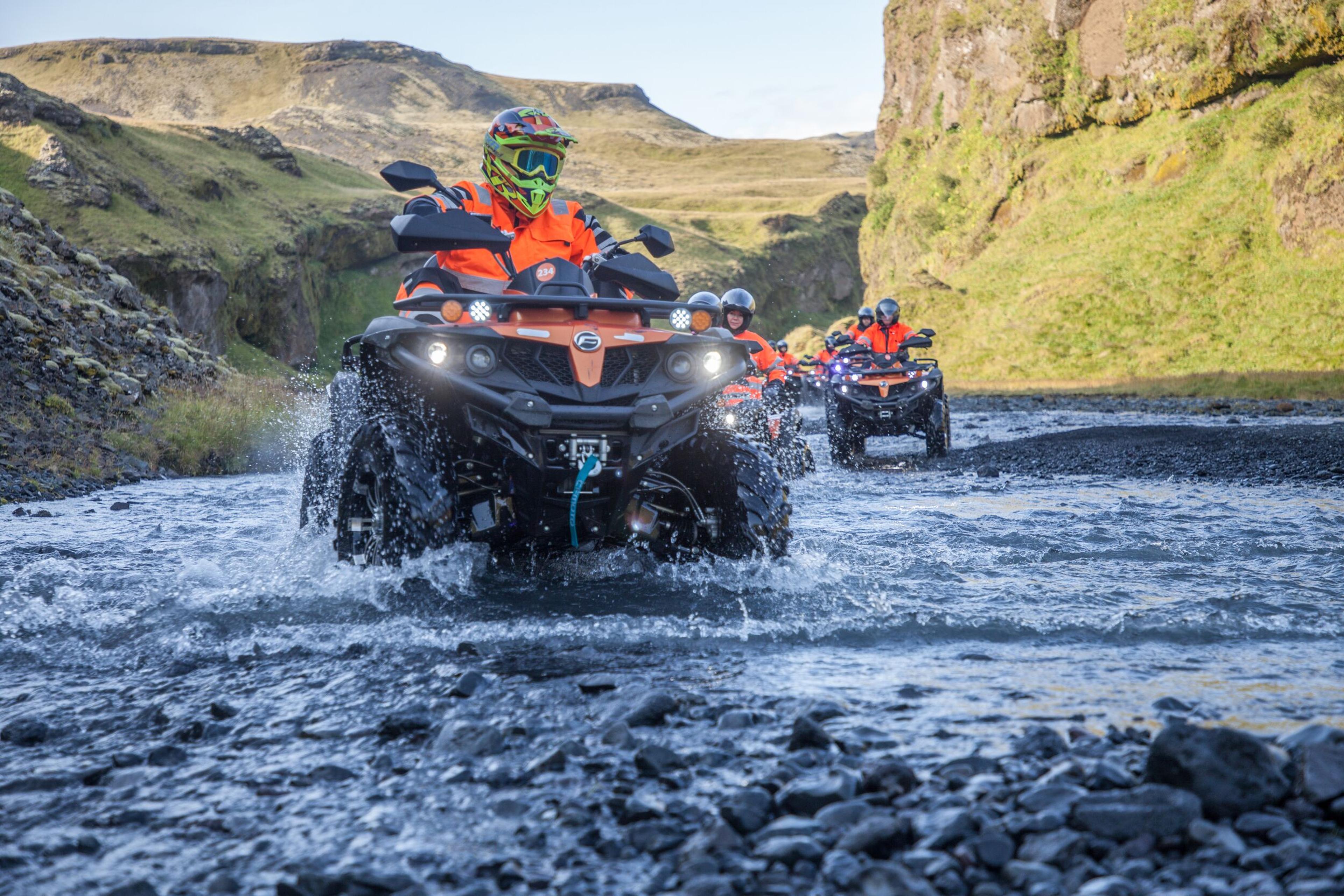 A rider crossing a river on a Atv in iceland