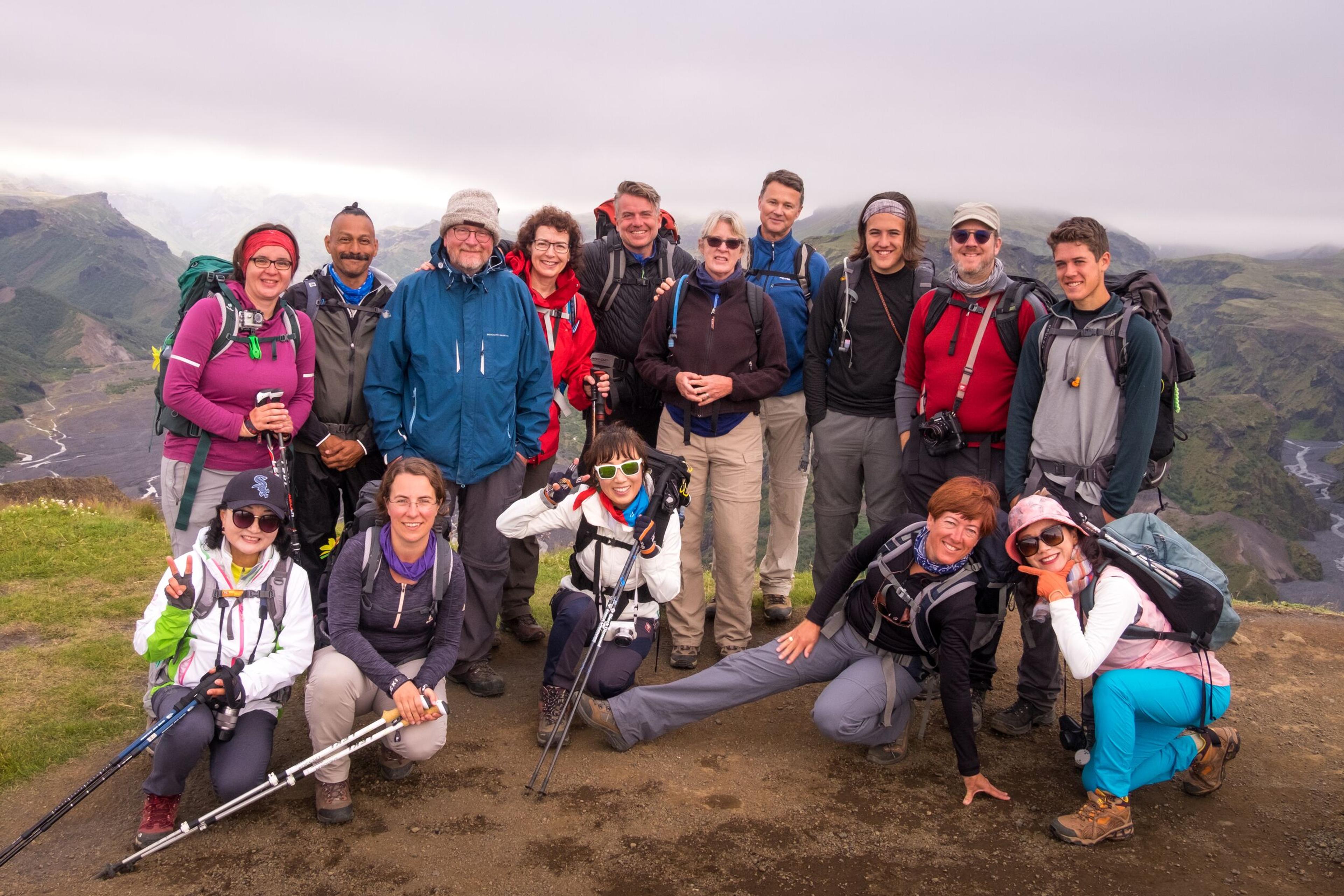 Group photo of hikers standing together at a scenic spot on the Laugavegur trail, smiling for the camera.