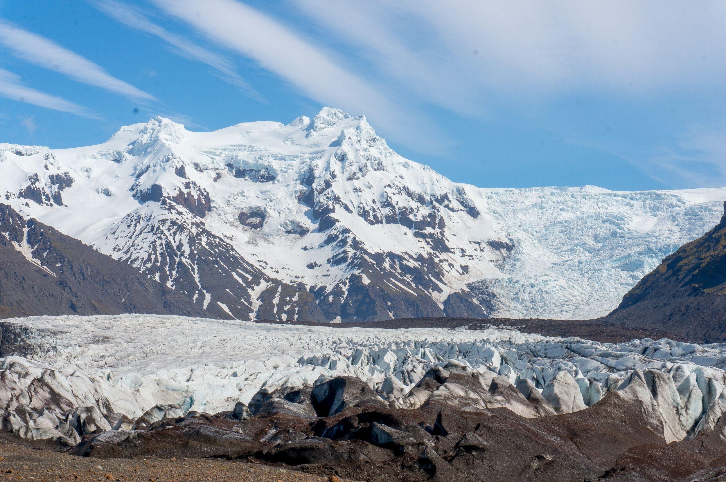 Hvannadalshnúkur, the highest peak in Iceland, proudly stands in the Skaftafell region, showcasing its snow-capped majesty against a vast Icelandic landscape.
