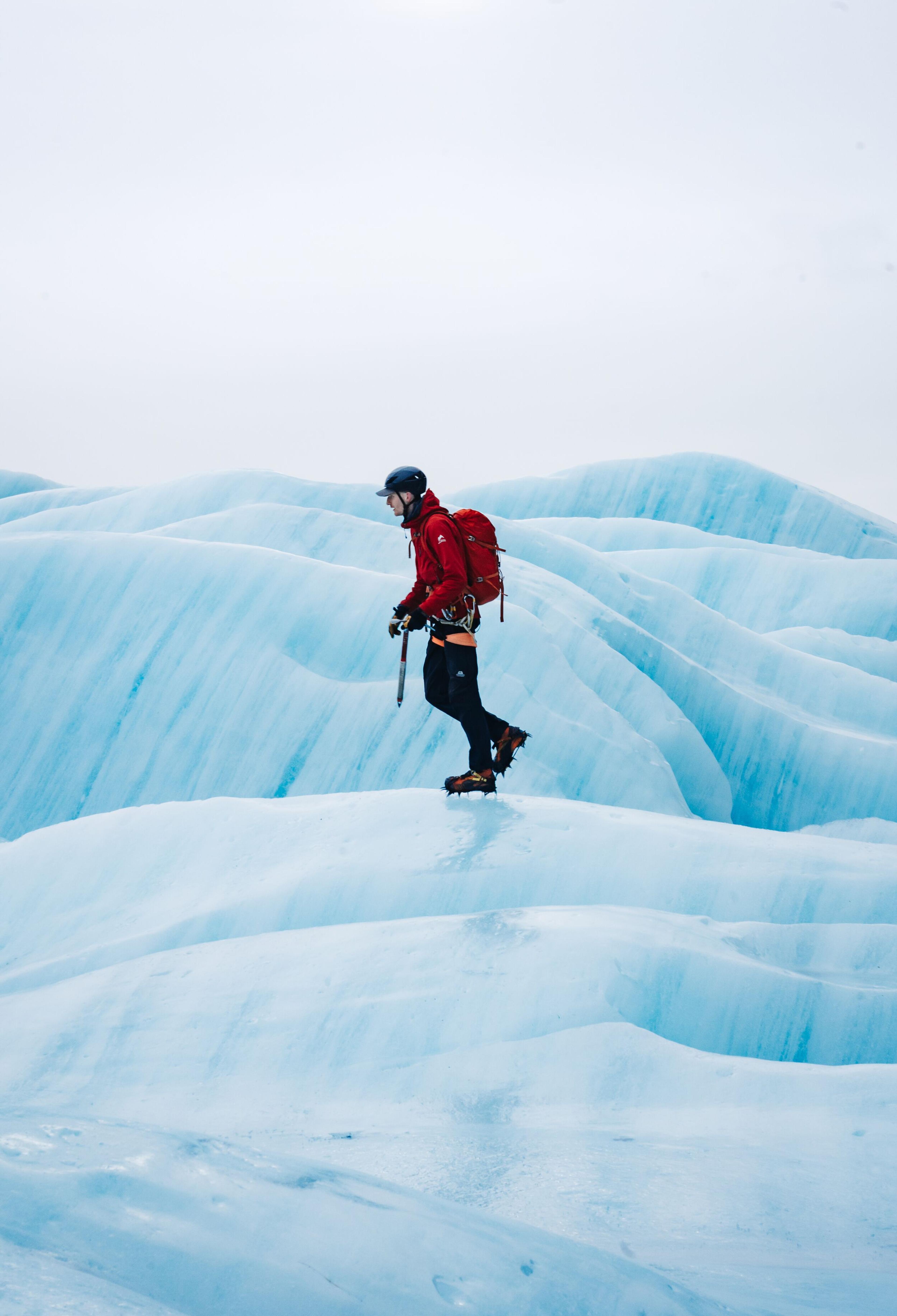 Explorer walking on a glacier in the South Coast of Iceland.