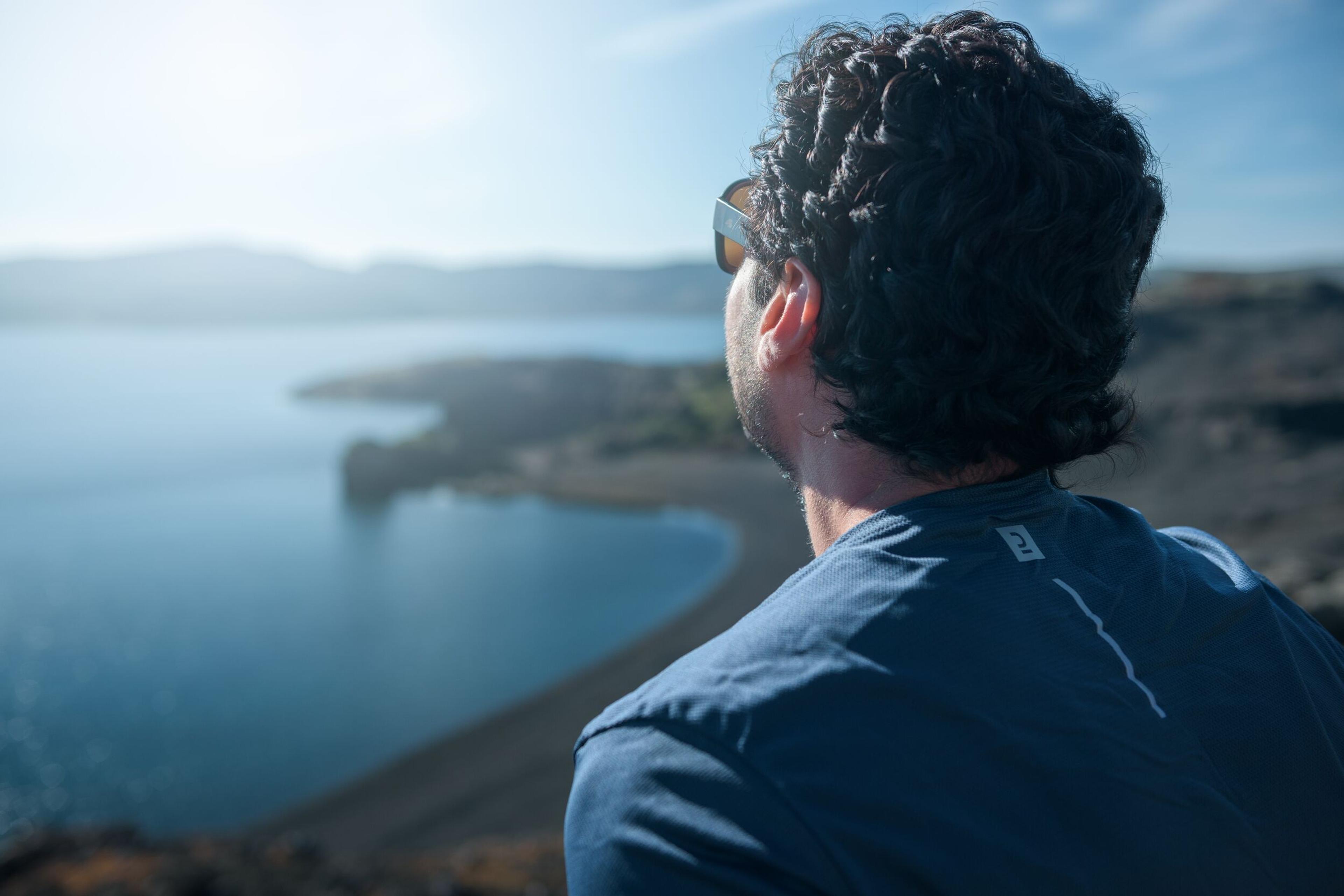 A man looking at Kleifarvatn Lake