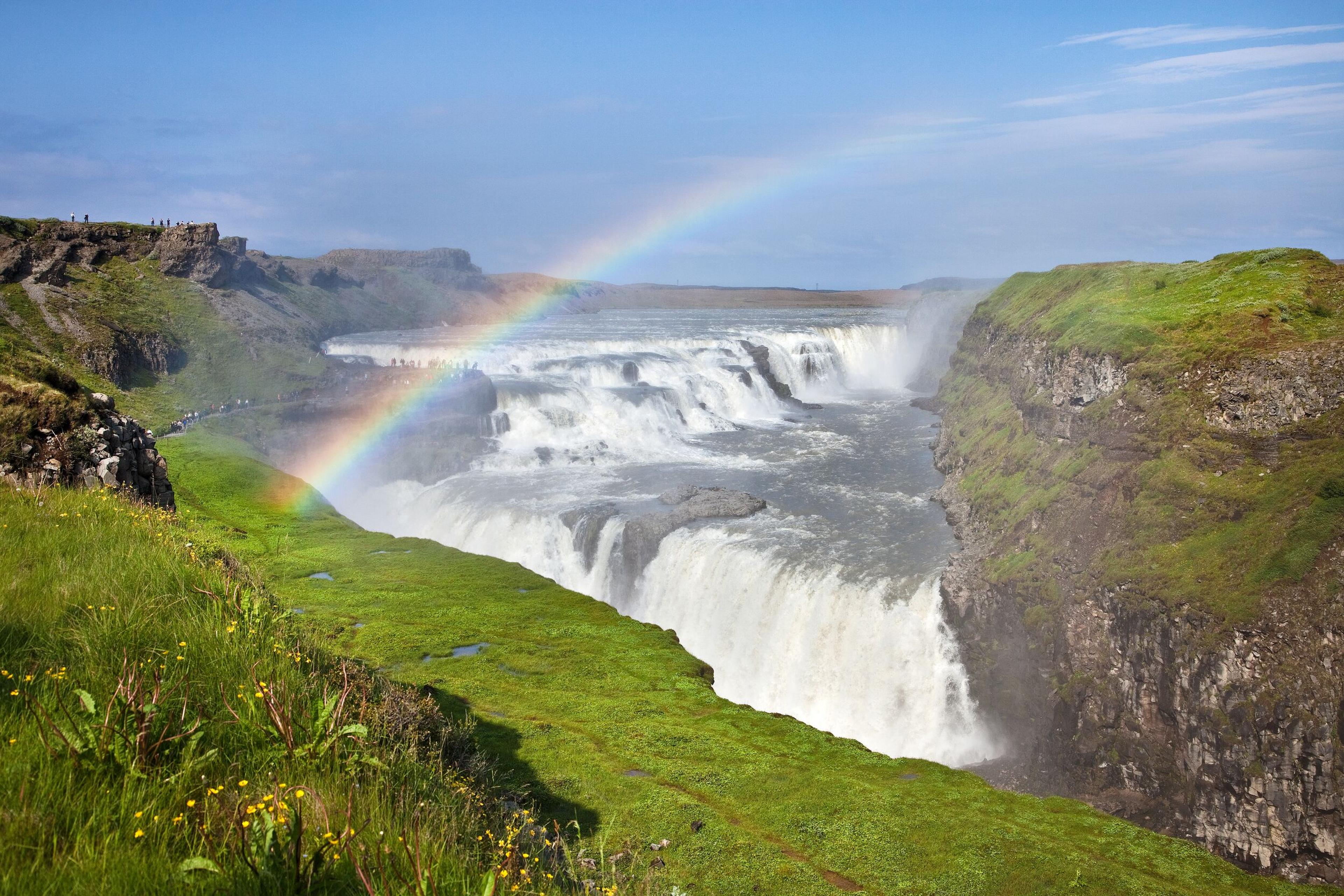 Gullfoss Waterfall during summertime with a striking rainbow.