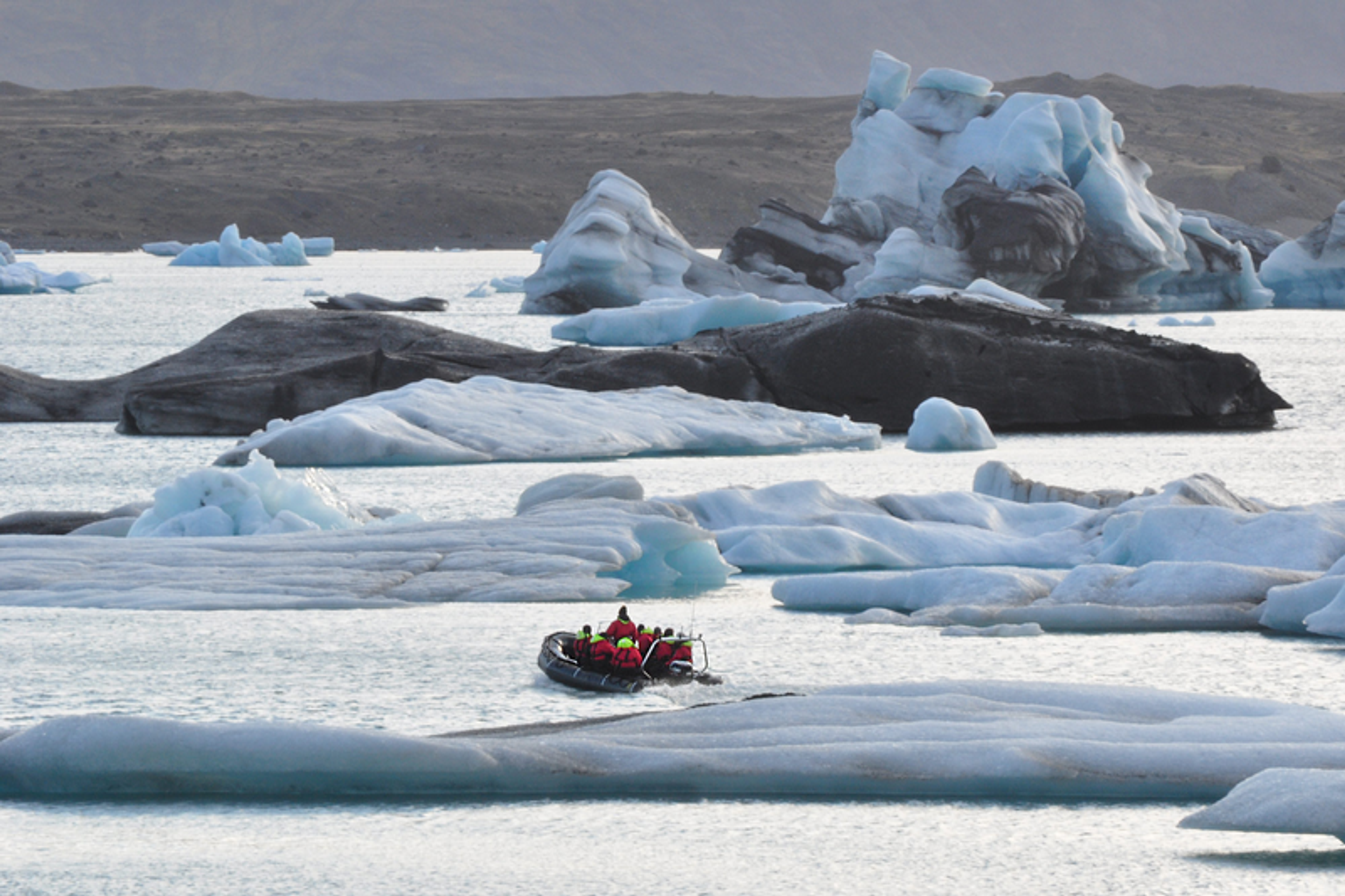 RIB boat speeding across the iceberg-filled glacier lagoon