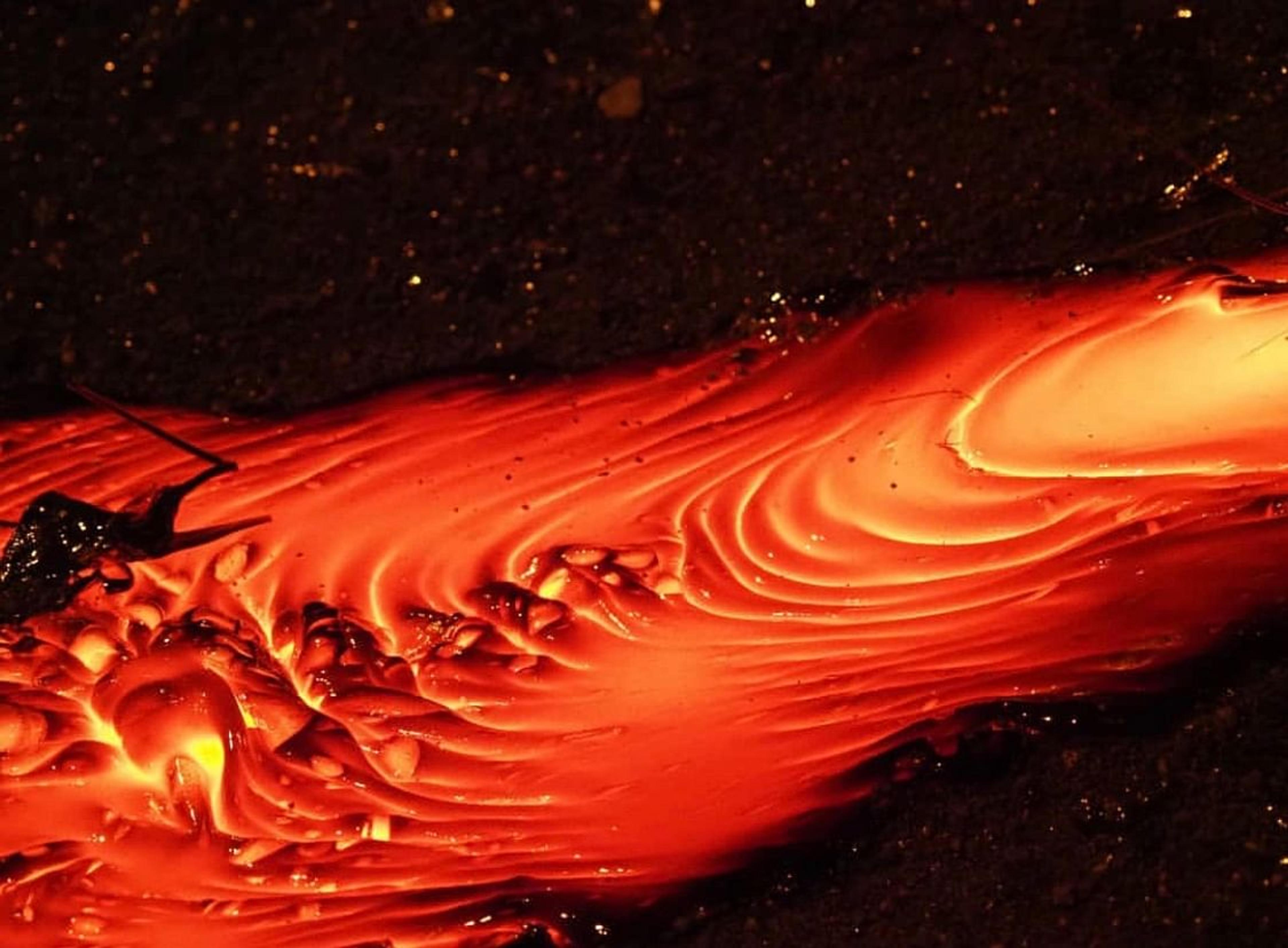 Flowing molten lava, glowing bright red and orange with ripples.