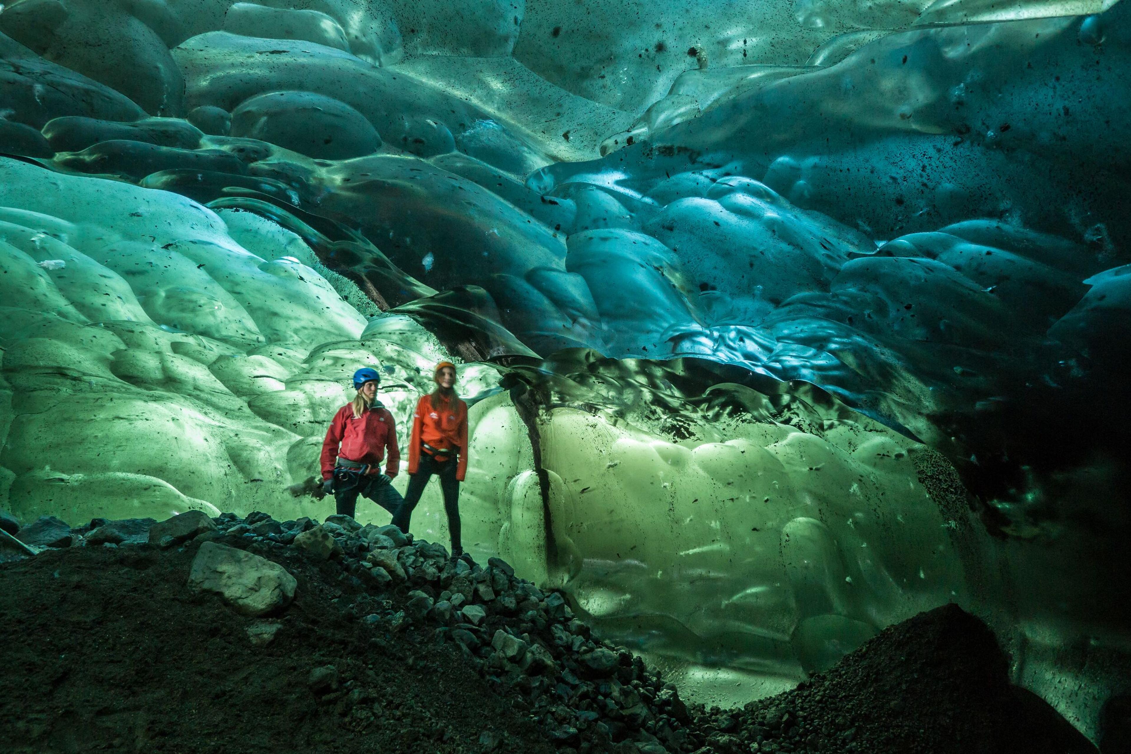 Two explorer inside an ice cave in Iceland.