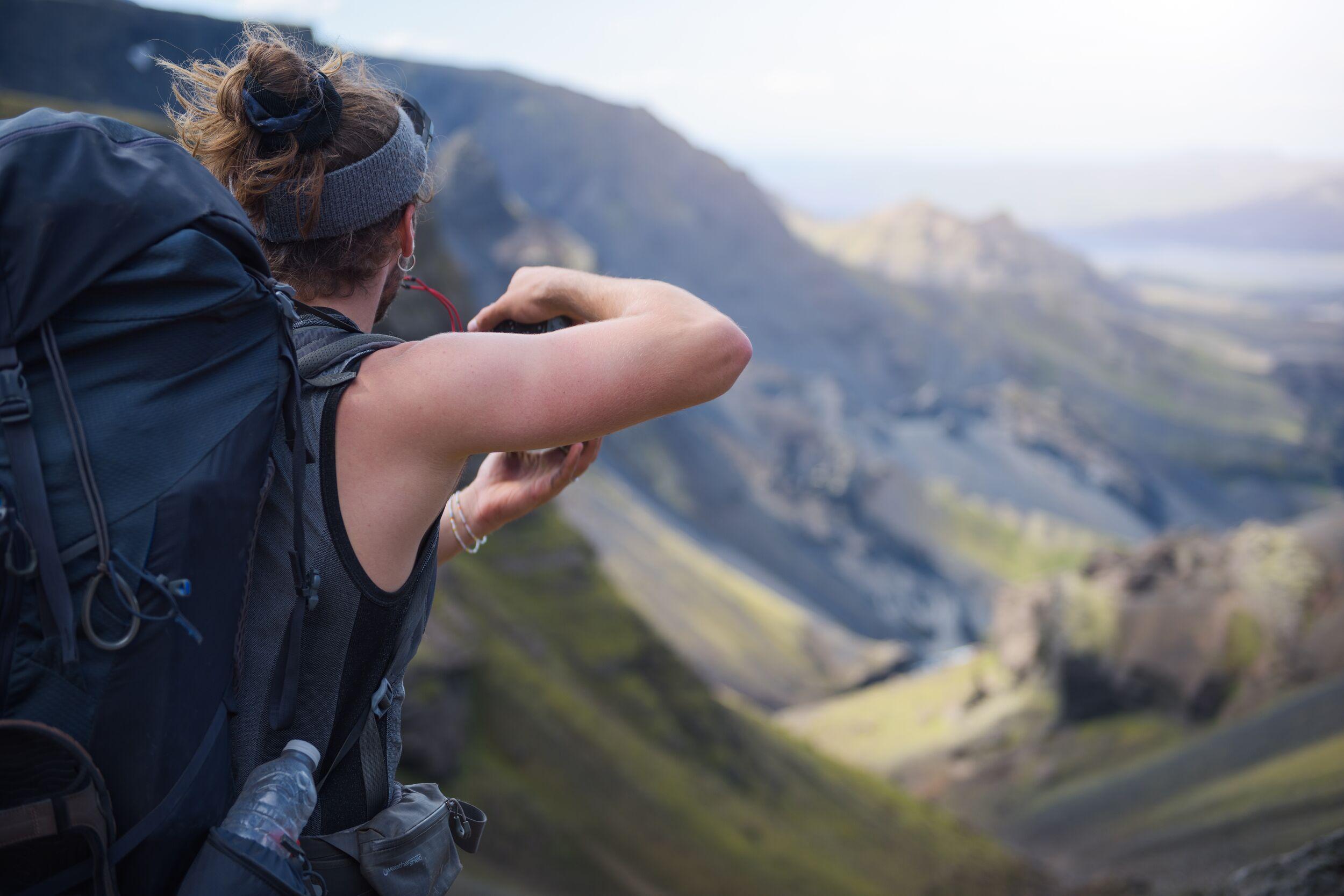 An explorer taking a picture in Fimmvörðuháls