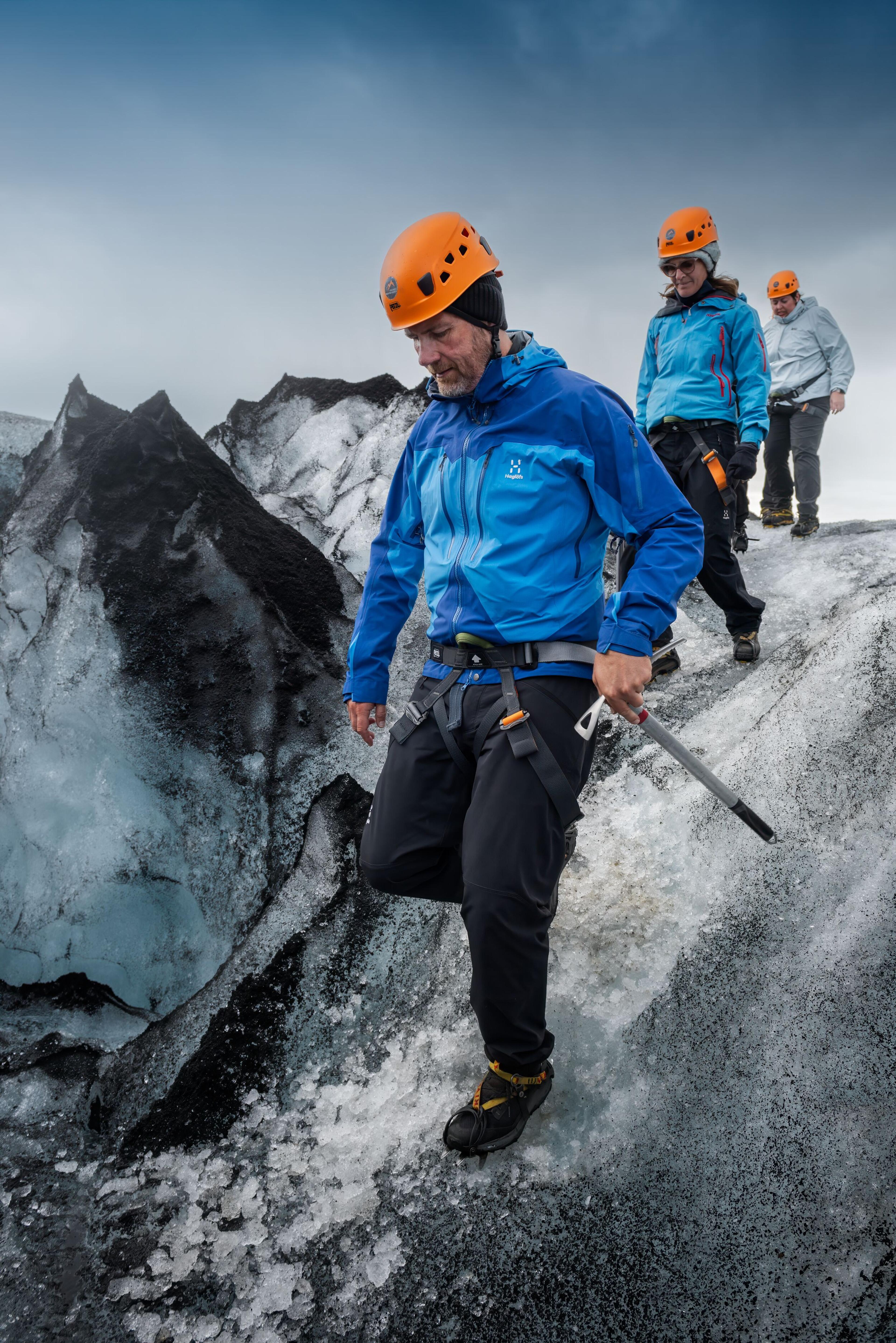 a man wearing a blue jacket that says haglofs on it