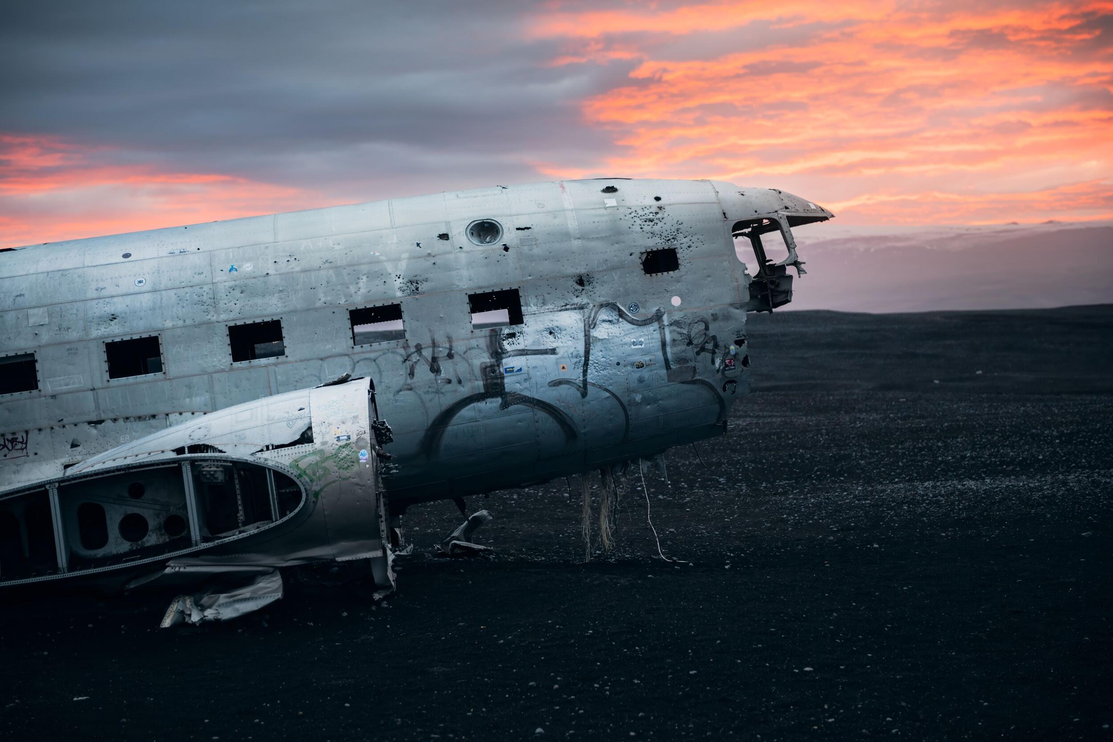 Abandoned plane wreckage in sunset 