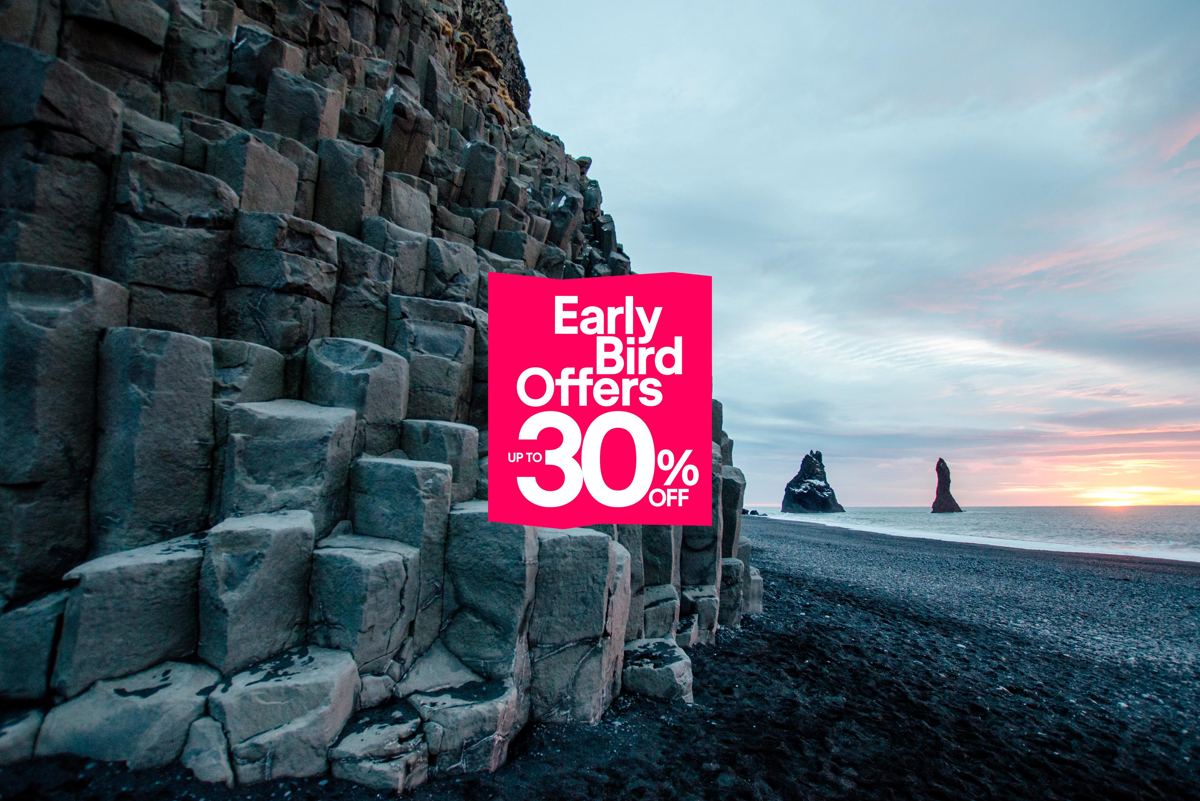 Early Bird Offers up to 30% off, overlaying a black sand beach with basalt columns and sea stacks at sunset.